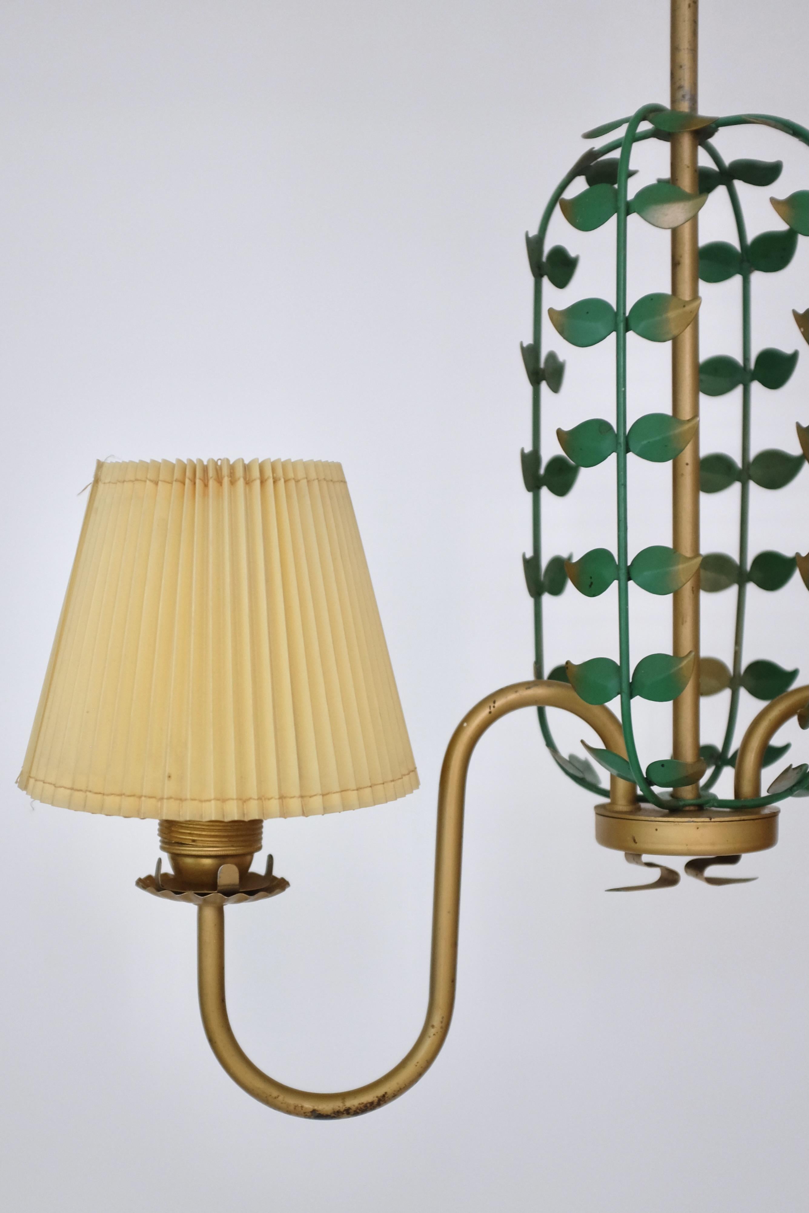 Swedish Modern Pendant with a decorative Leaf Cage between two curved lamp arms. Painted metal in gold and green with original pleated plastic shades possibly for outdoor use. Very decorative and showcasing the soft elegant lines of Swedish mid-20th