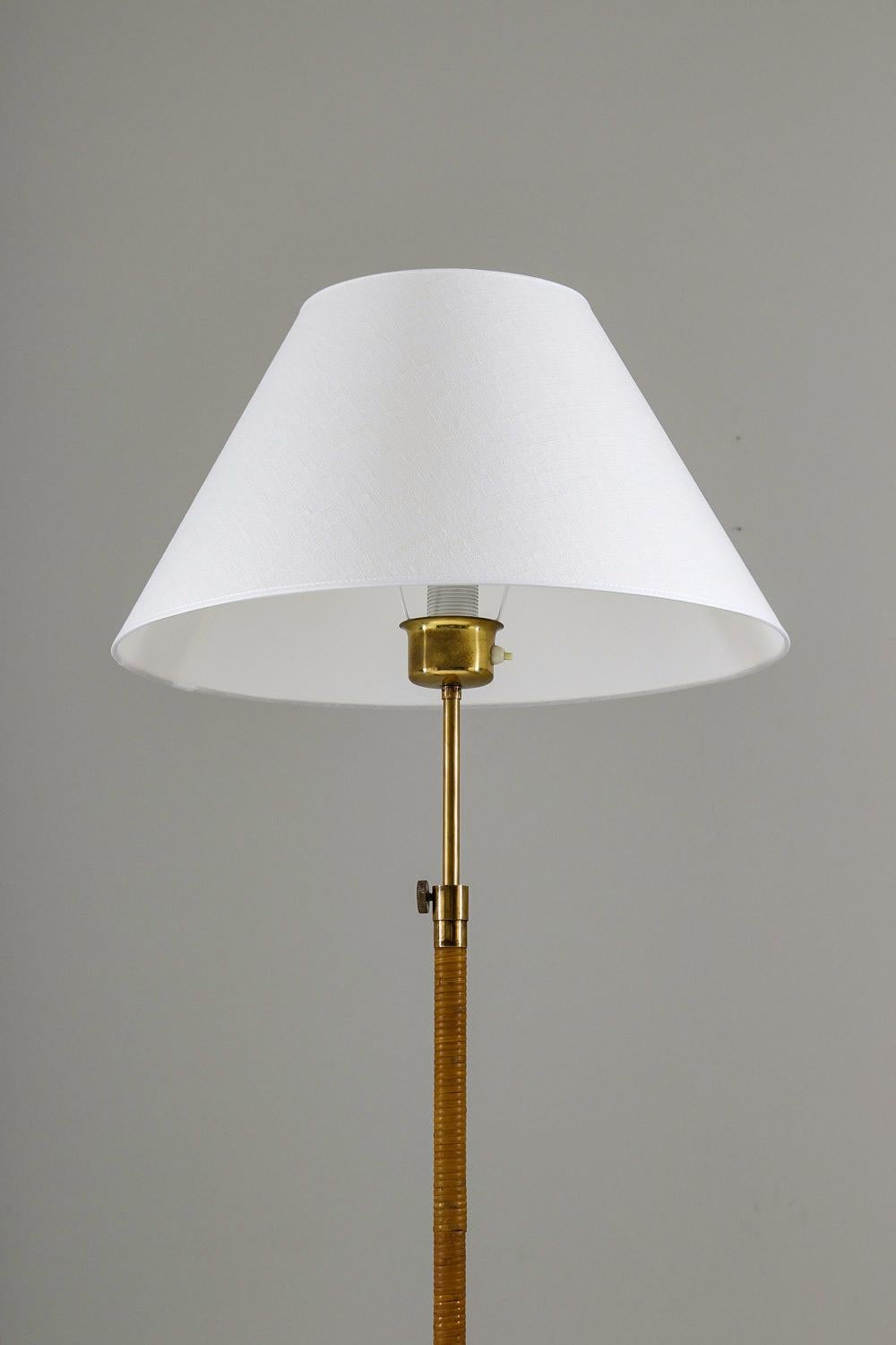 Rare floor lamp, probably manufactured by ASEA, Sweden, 1940s.
Very elegant lamp of beautiful design. The foot holding the lamp is a piece of art in itself and has perfect patina. The pole is entwined in rattan, with details in brass, such as the