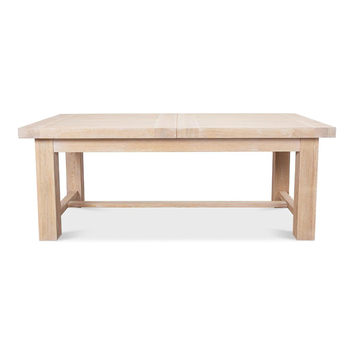 A Swedish modern oak extension dining table. This contemporary bold thick top oak dining table is raised on a substantial base with an H stretcher. 

Open dimensions: 110