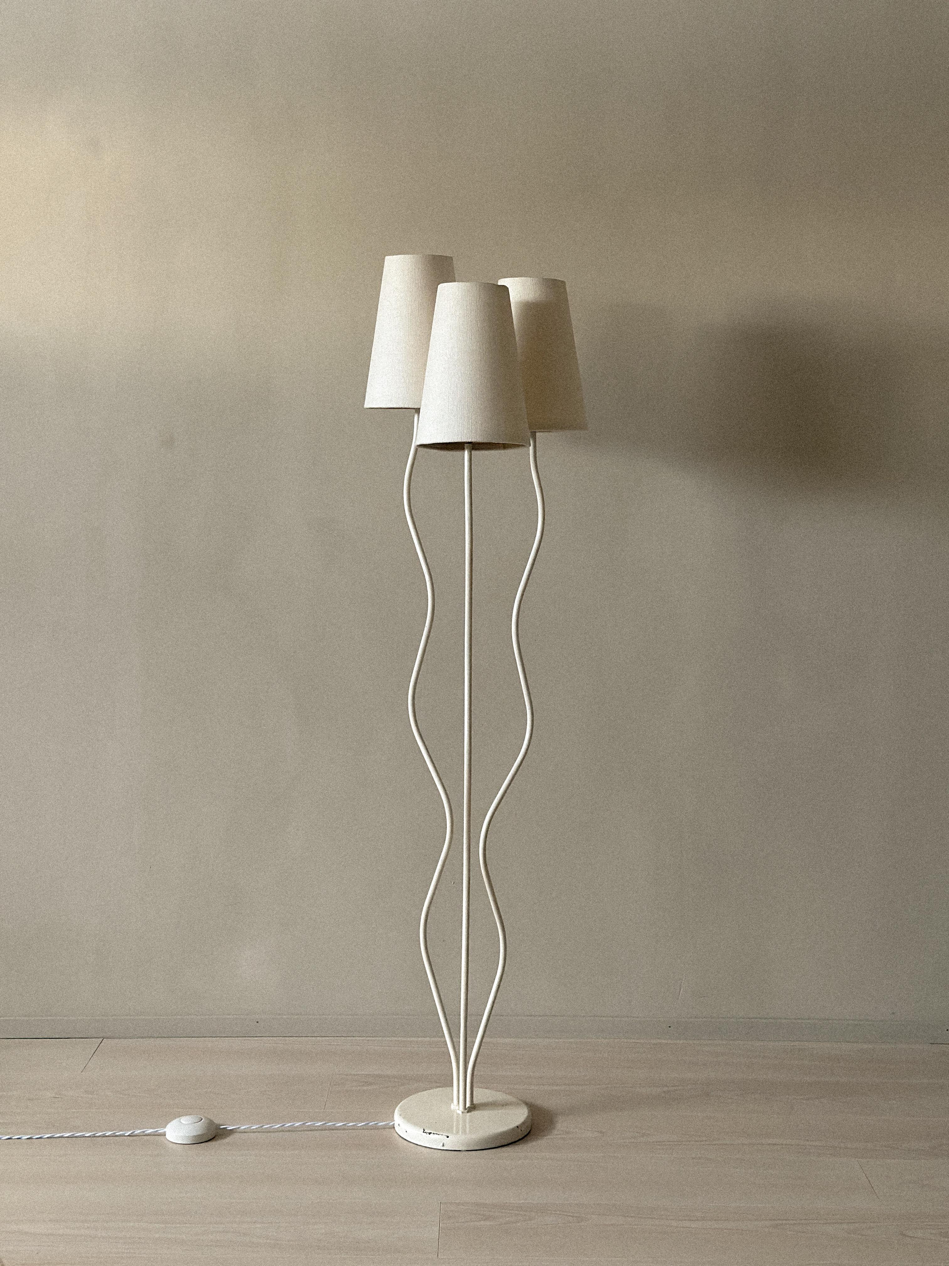 A 1950s Swedish floor lamp with three organically shaped metal bars and simple linen shades. Clean lines and a sculptural design make it a striking, functional piece for any interior.

In good vintage condition, showing light patina and wear