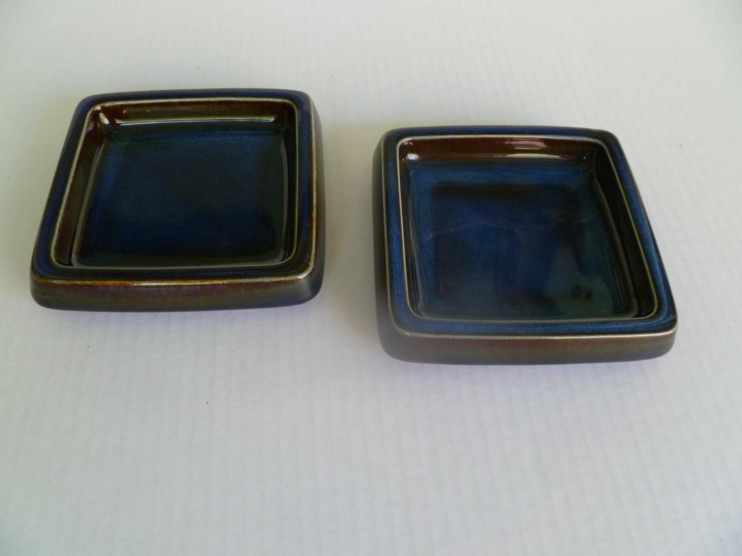 A pair of Swedish Mid-Century Modern shallow Lagun 3 stoneware vessels by Sven Jonson for Gustavsberg, 1970s. Heavy stoneware catch-all bowls or ashtrays, glazed in a thick rich blue glaze with earthen overtones.
Incised on bottom with Gustavsberg