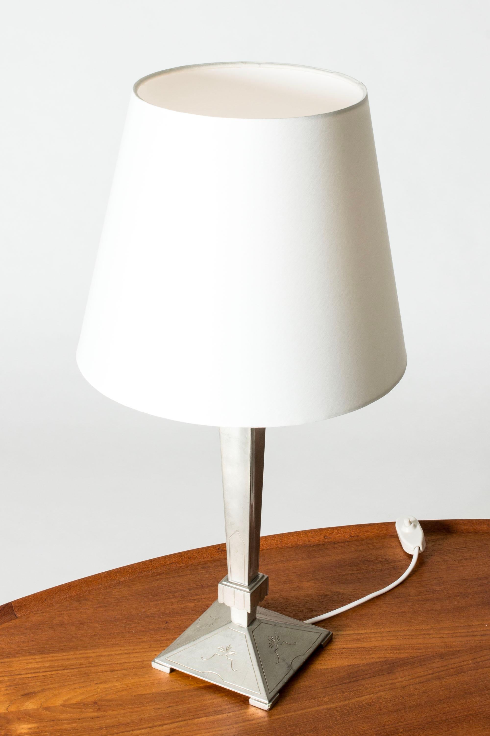 Elegant Swedish Modern table lamp from B.H. Edlunds Silverfabrik, made from pewter. Tapering handle with a square base and art deco decor.