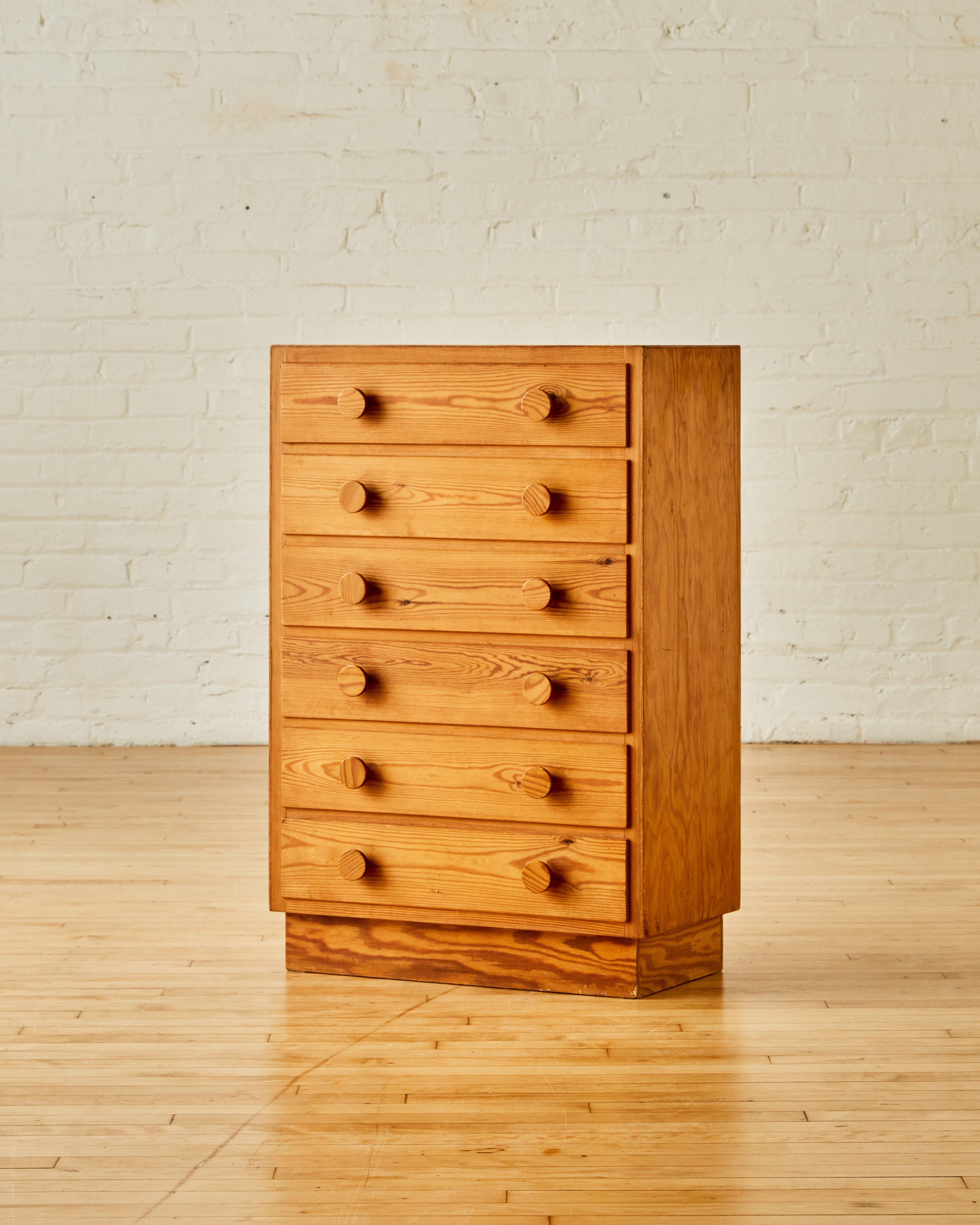 Swedish modern pine tallboy with six drawers and rounded handles.

