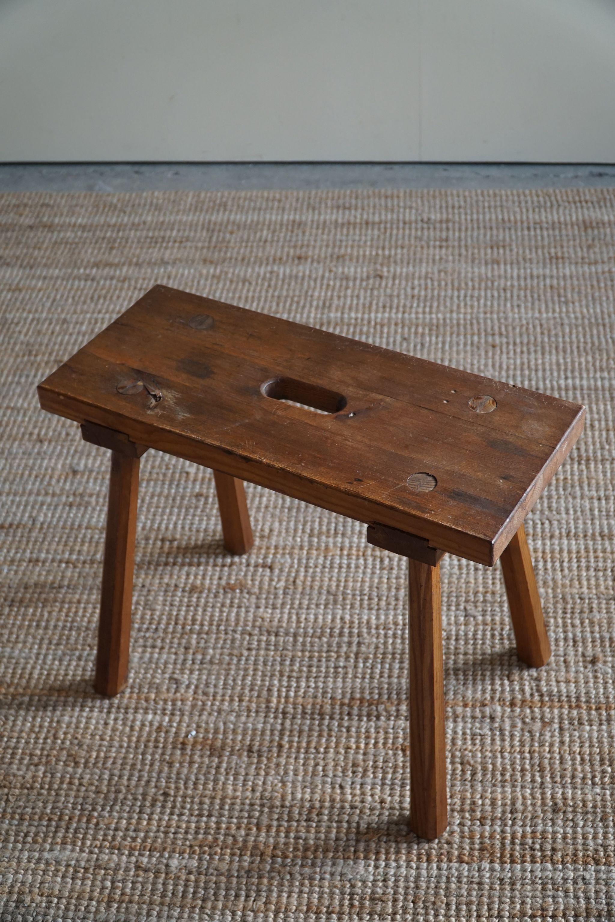 An early work by Swedish Deisgner Carl Malmsten. A rare wooden brutalist stool with a great warm patina. Made in the early 50s. Signed underneath.