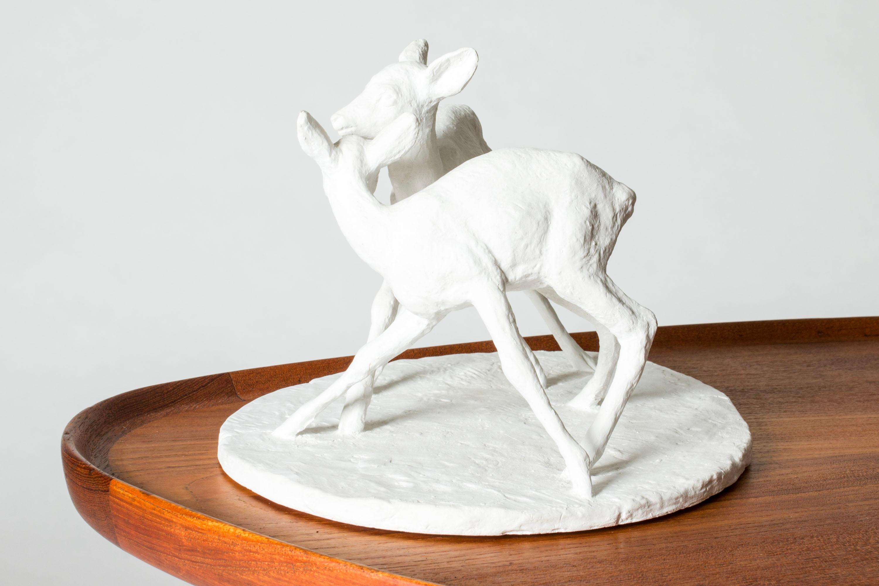 Lovely plaster figurine by Arvid Knöppel, in the form of two endearing roe deers greeting each other or playing.