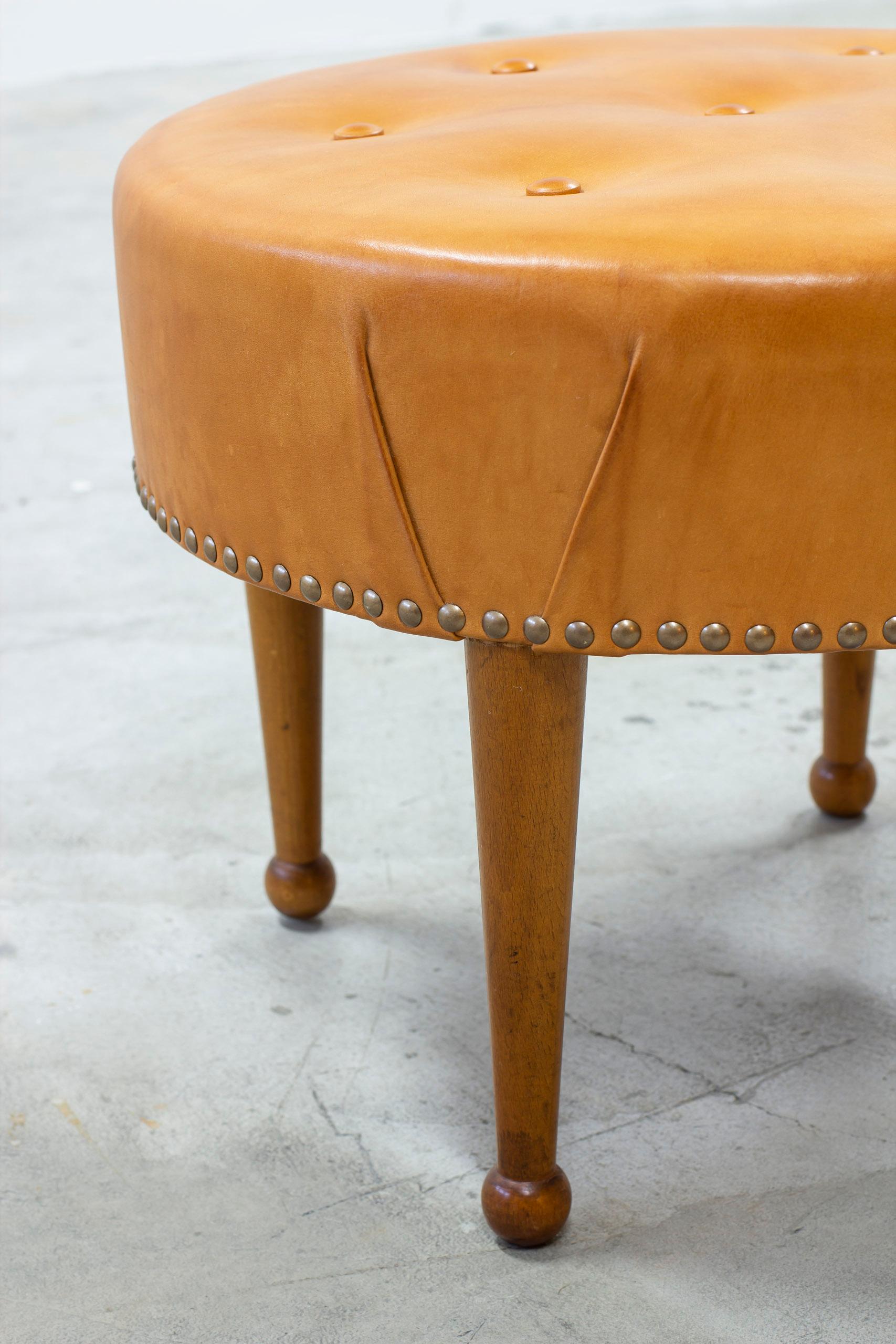 Brass Swedish modern round leather tabouret in the style of Josef Frank, 1940s
