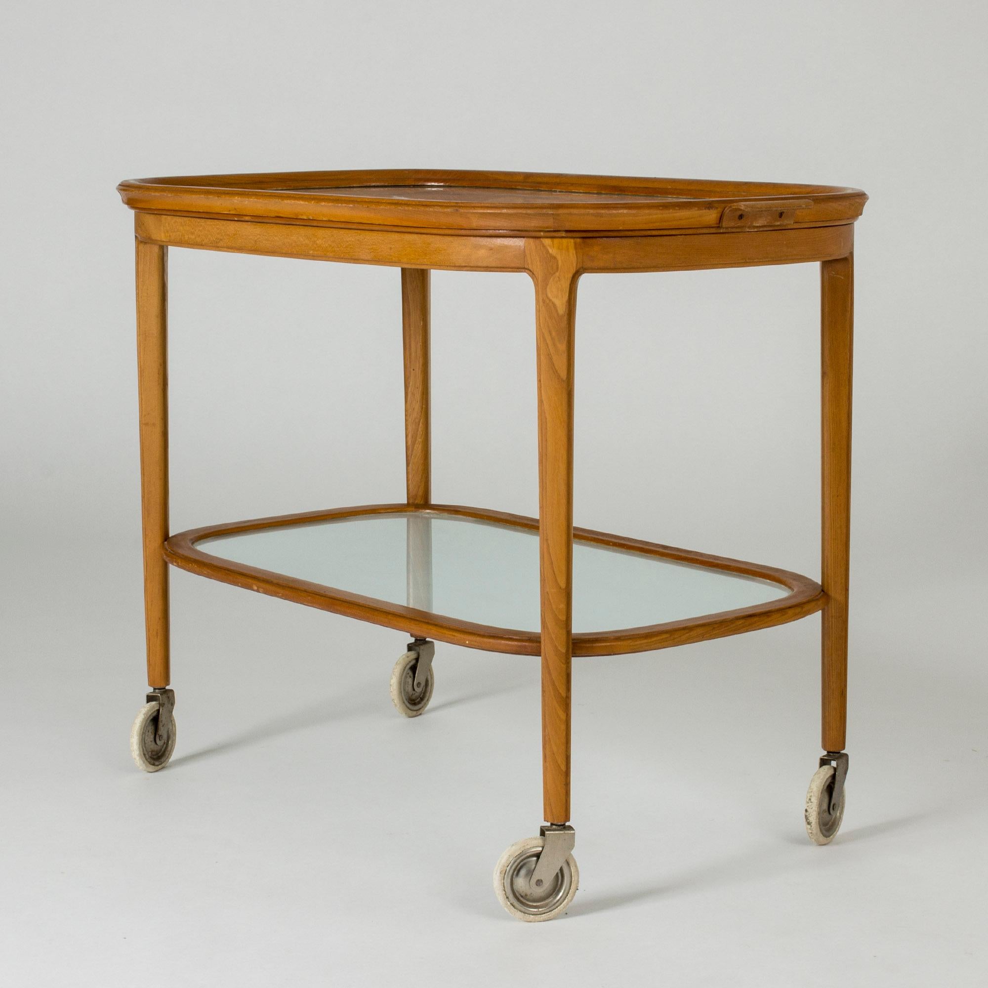 Beautiful Swedish midcentury serving trolley with a removable top tray. Made from elmwood with glass shelves. The top has a decorative etched diamond pattern.