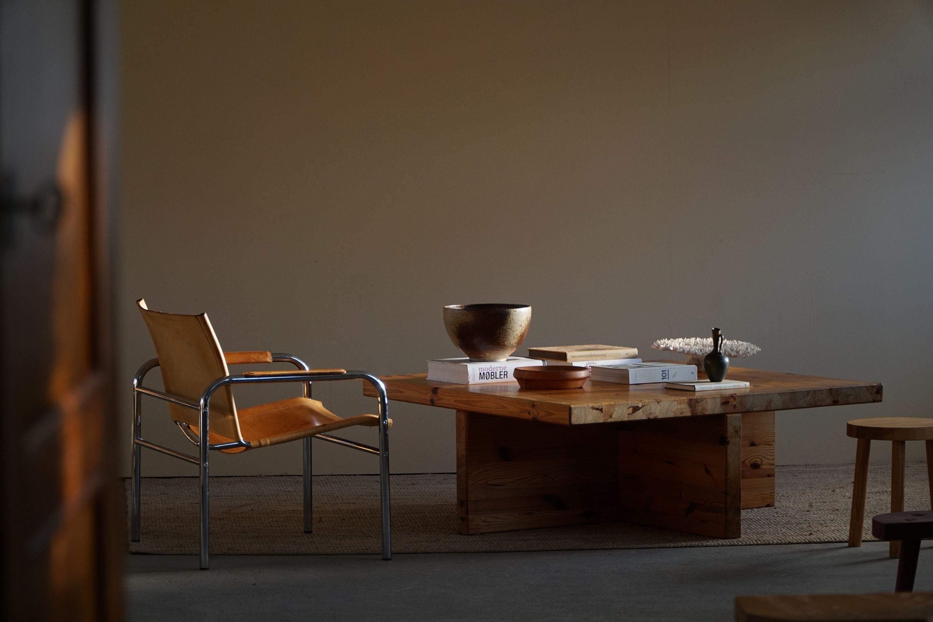 Large square coffee table in solid pine, made by Sven Larsson in 1970s.

A great brutalist object, perfect for the modern interior. A warm colour and patina that pair well with the minimalist scandinavian lifestyle. Scandinavian design is