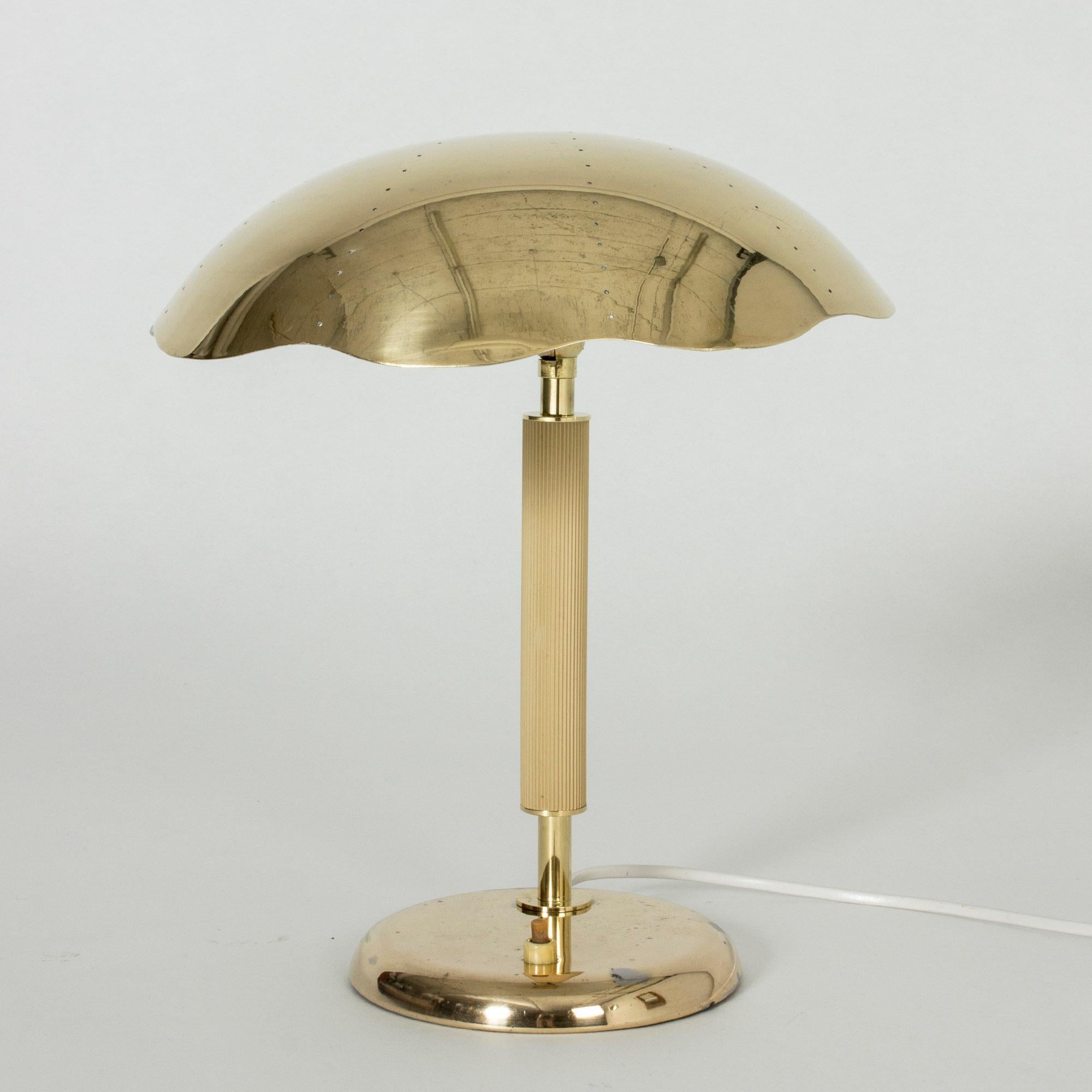 Neat Swedish Modern brass table lamp from Böhlmarks, with a wavy edged shade, perforated with small holes.