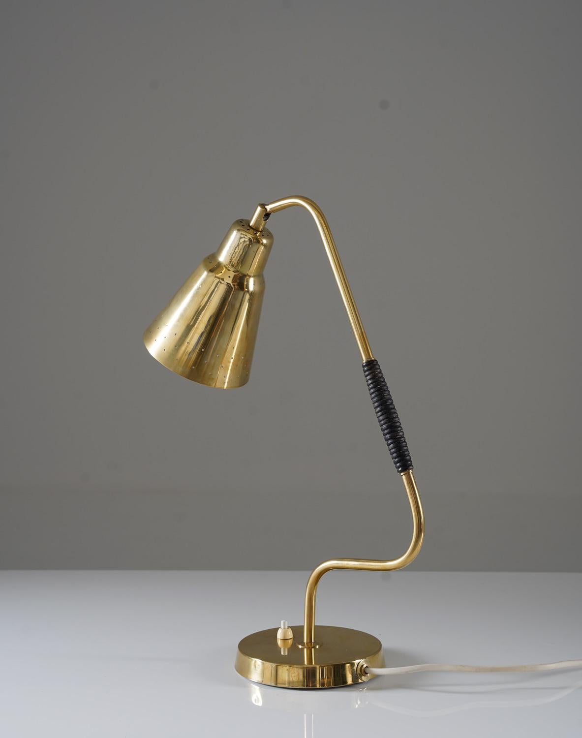 Introducing a rare and early table lamp by Bergboms. This stunning lamp is made of solid brass, with a perforated shade and a wooden handle on the rod. It uses an E-14 bulb, with a maximum wattage of 25W.

Bergboms was a Swedish manufacturer of