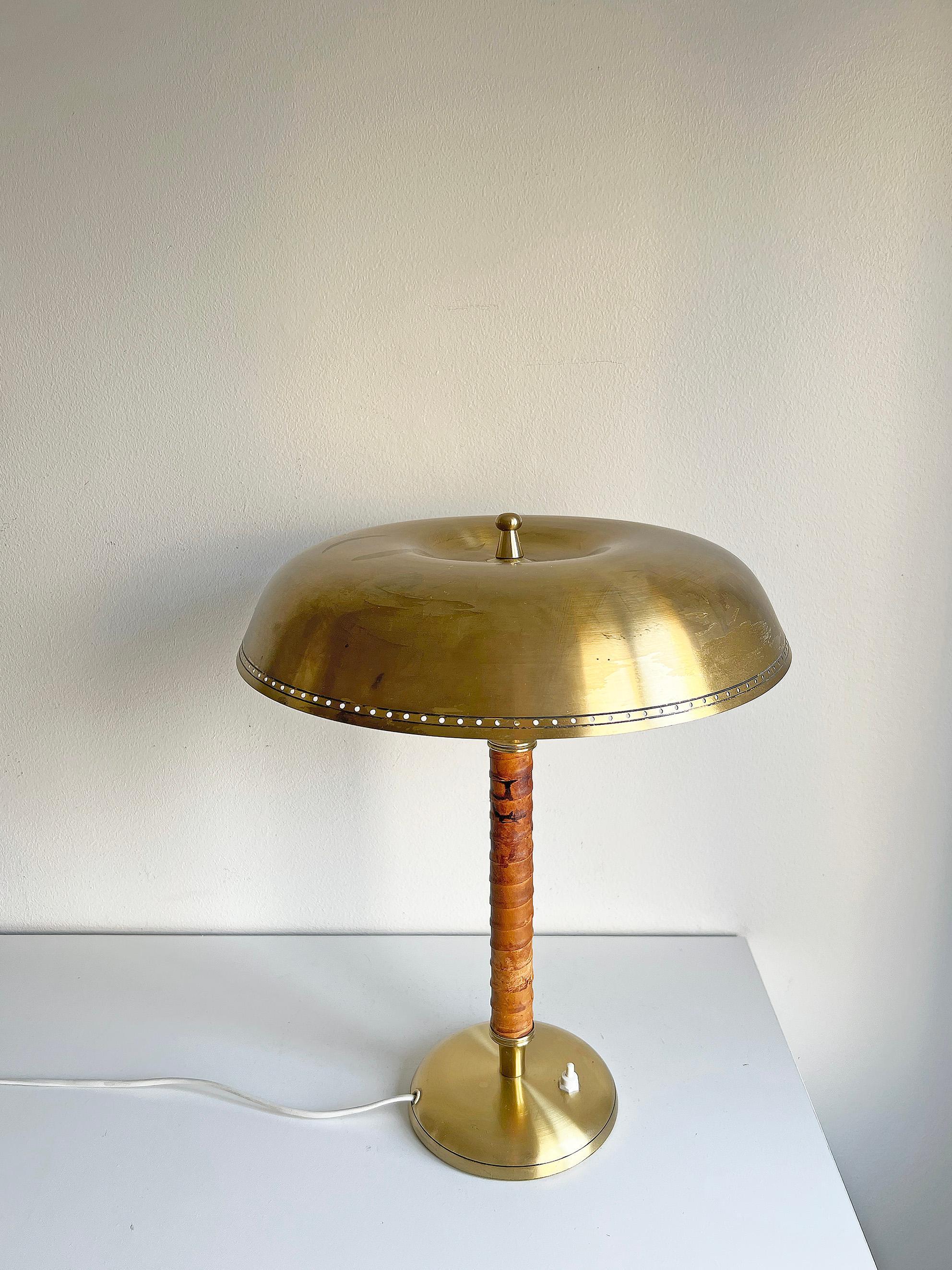 Rare table lamp model 8452 by Boréns, Sweden. 
Signed with makers mark.
Condition: Good vintage condition, wear consistent with age and use, brass and leather patina. 
The shade is slightly slanted.
Rewired. We recommend this lamp to be rewired
