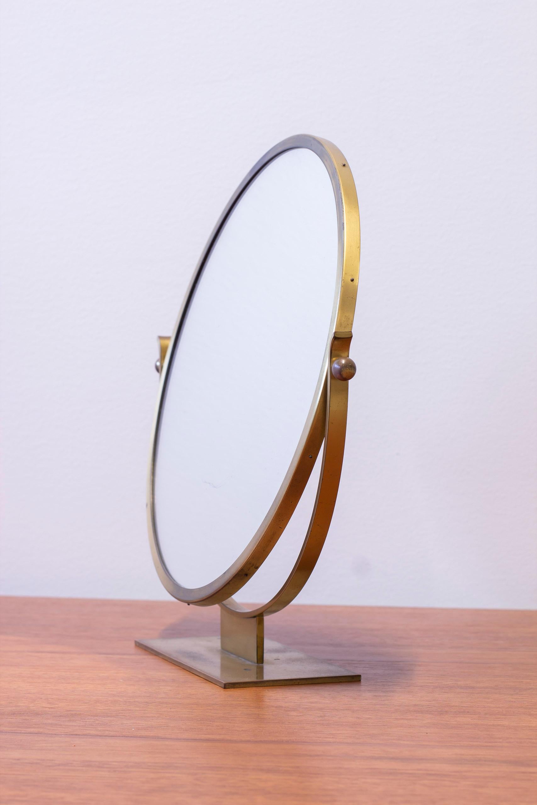 Miroir de table moderne suédois produit par Ystad-Metall en Suède. Fabriqué dans les années 1930-40. Design/One élégant et moderniste en laiton massif qui s'est joliment patiné avec le temps. Angle réglable. Signé sur le fond avec le poinçon
