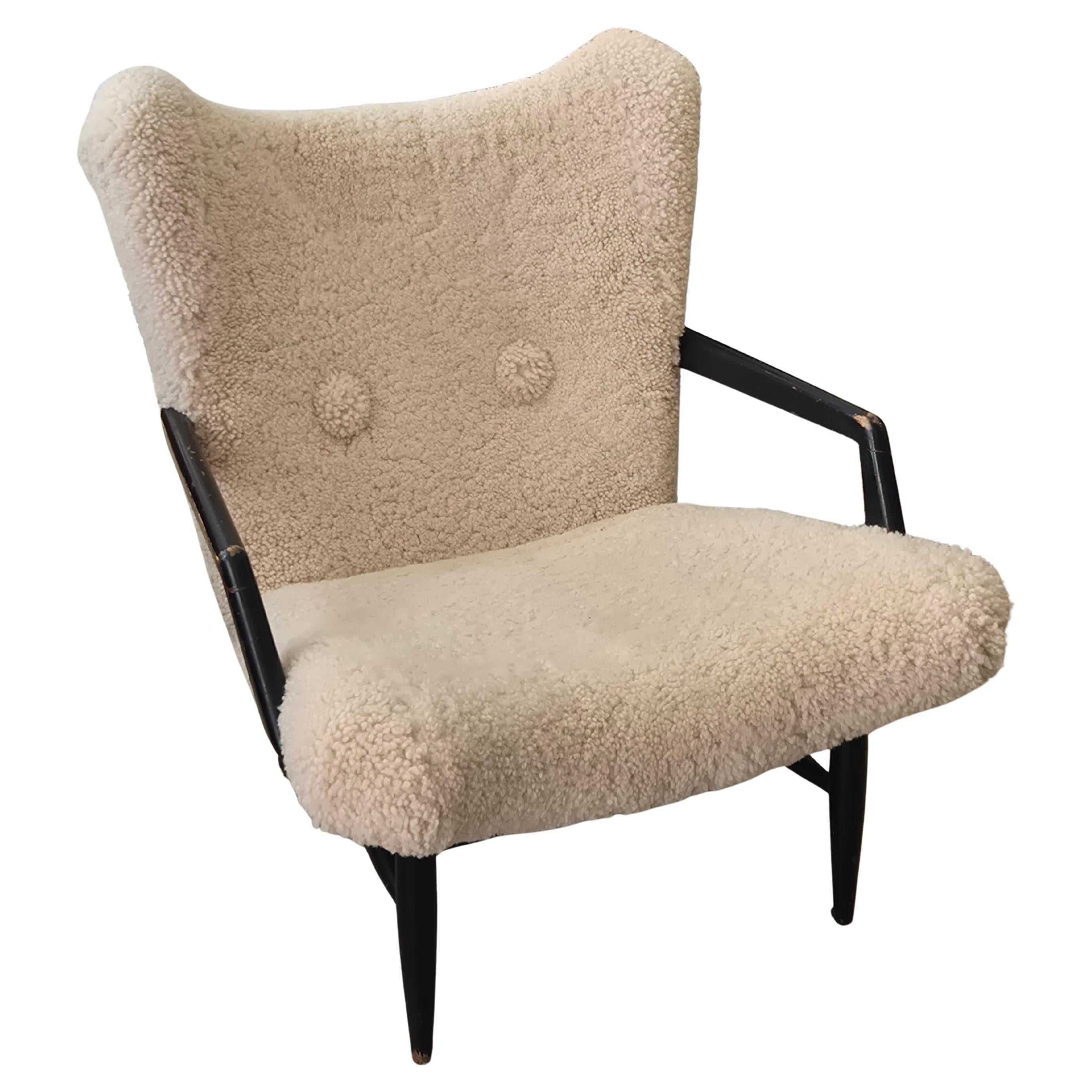 Swedish Modern, timeless easy chair in sheepskin, by Svante Skogh. Nice patina. For Sale