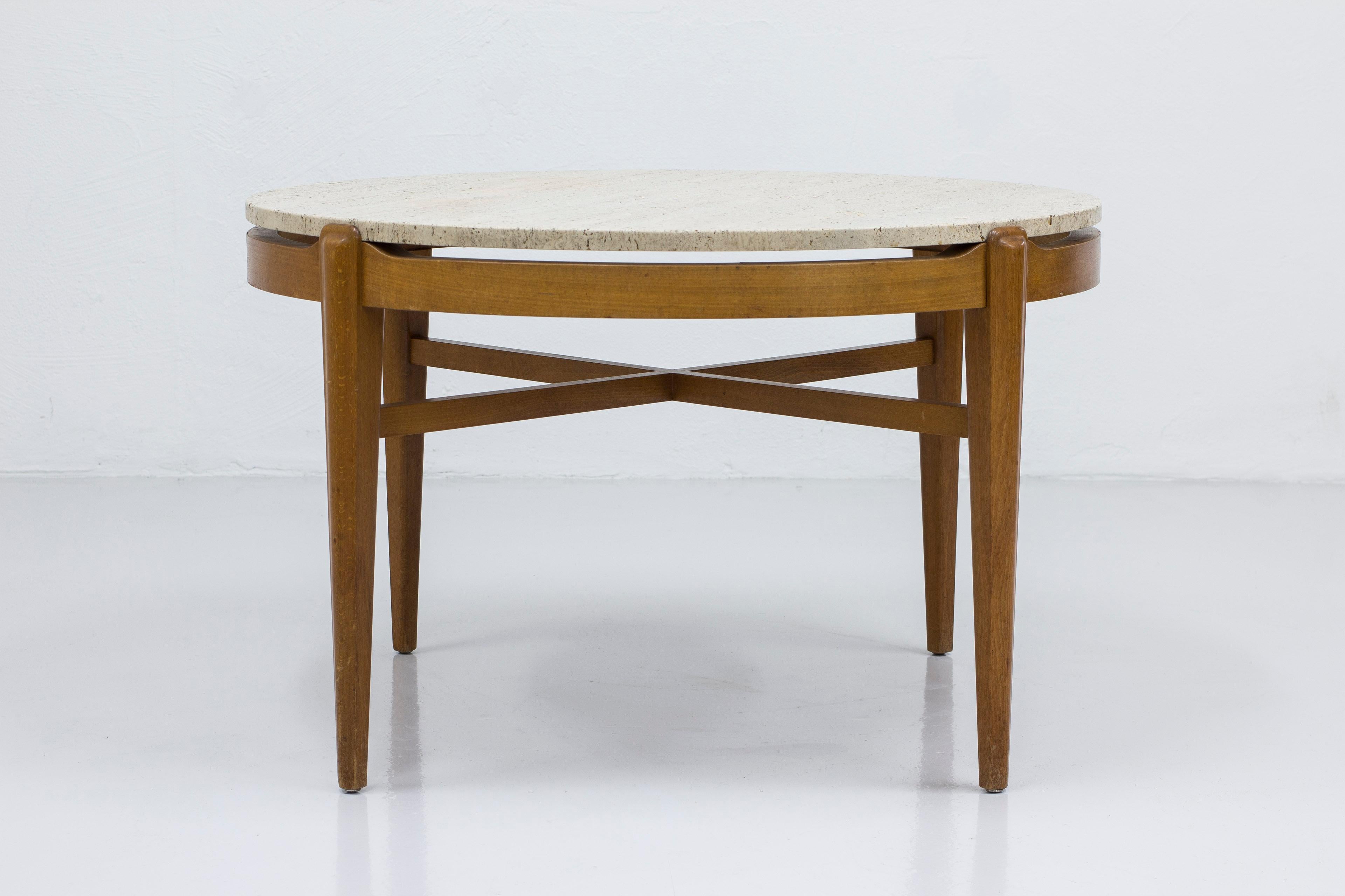 Swedish modern coffee table designed and made in Sweden. Produced between the 1940-50s. Made from stained beech with tapered legs and travertine table top. Very good vintage condition with light age related wear and patina.



Designer: