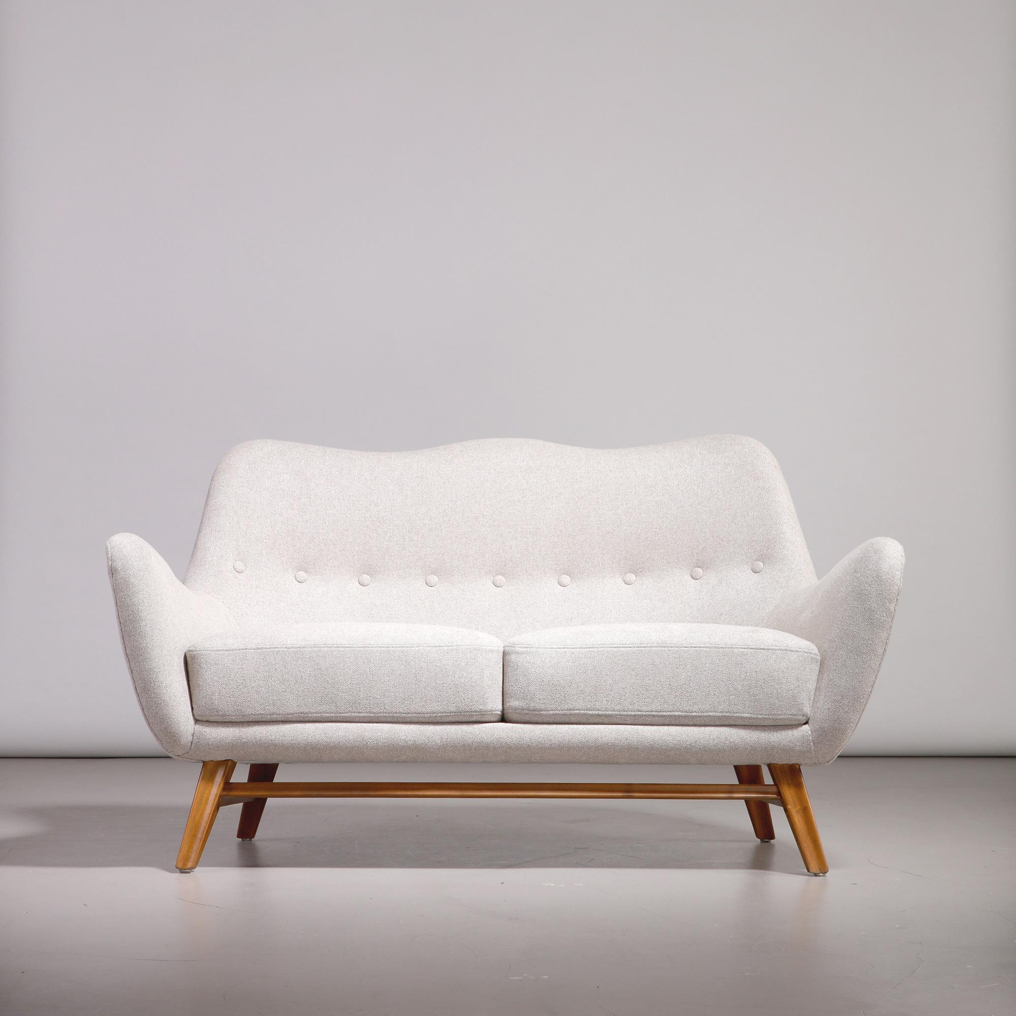 Swedish Modern two-seater sofa, made by a Swedish cabinetmaker in the 1950s. Legs in stained wood, recently reupholstered in light fabric. The sofa features a refined, sculptural form with an elegant silhouette and generously proportioned armrests