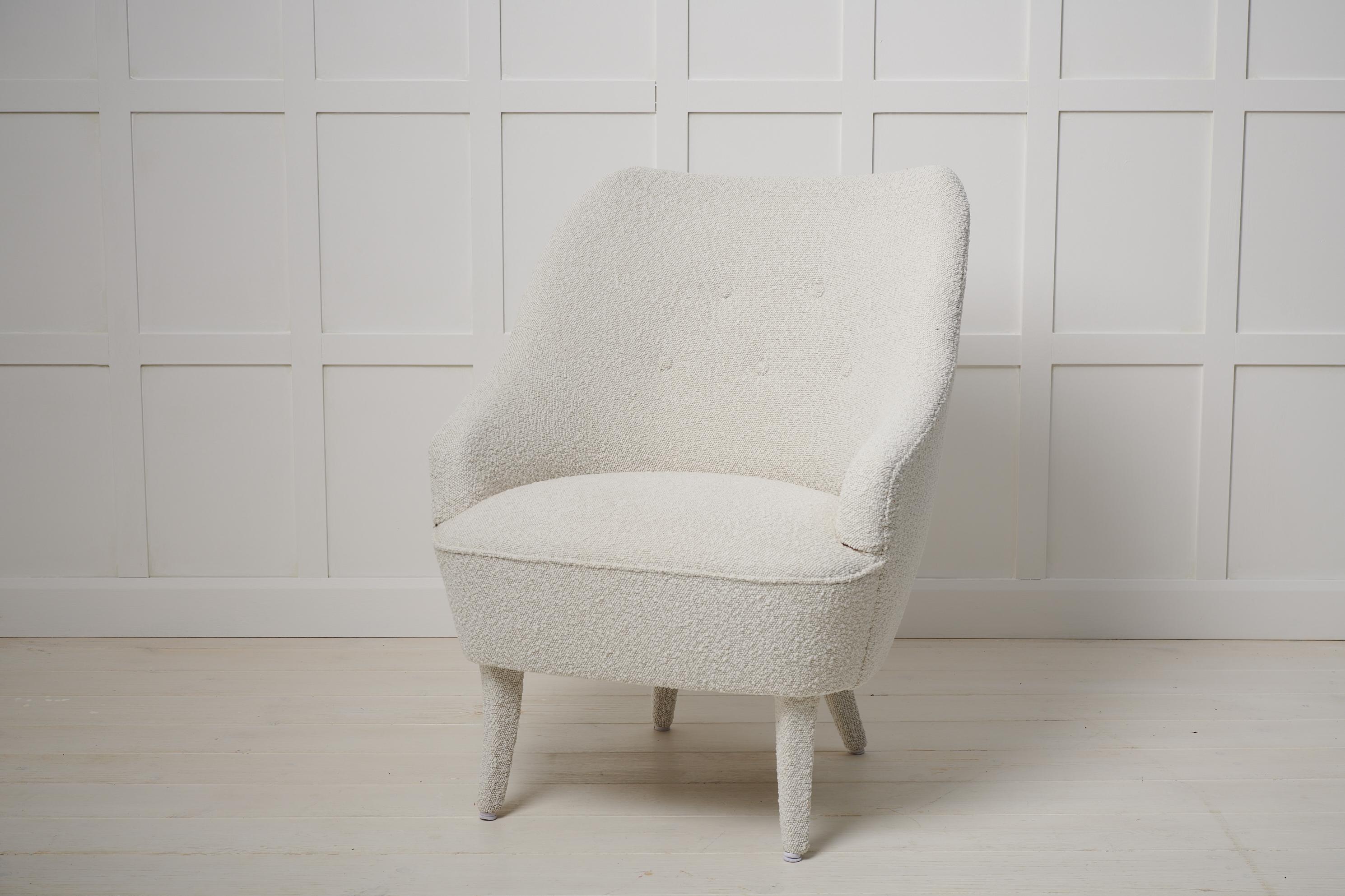 Swedish modern vintage armchair from the 1930s to 1940s that’s been newly renovated. The armchair has renovated padding with new upholstery in boucle fabric. The legs have been upholstered with the same fabric for a seamless look. Swedish modern