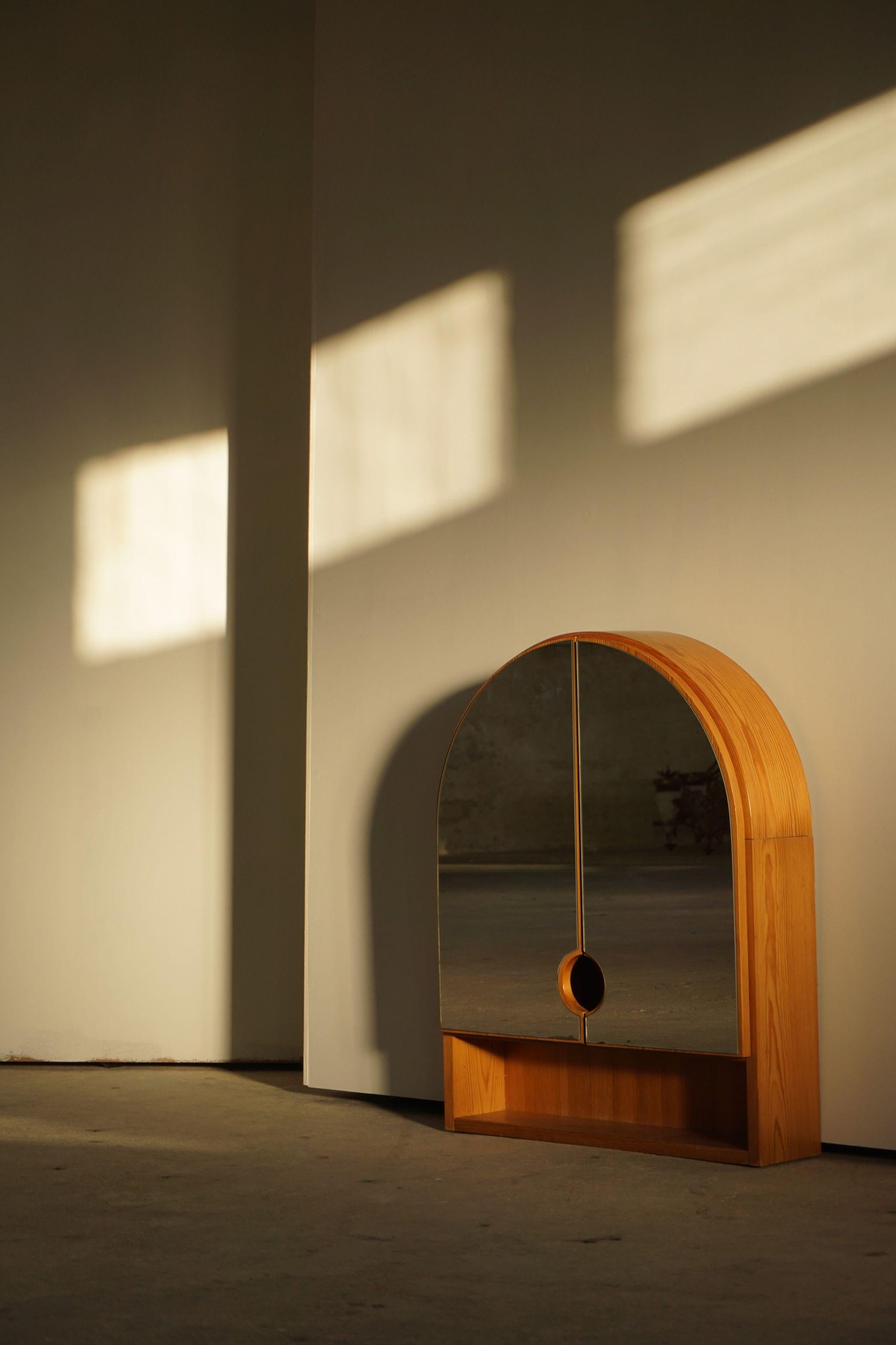 Decorative Swedish modern wall mirror in pine, suitable as bathroom mirror. Made by a unknown cabinetmaker.

Honorable mentions in similar style include Roland Wilhelmsson, Pierre Chapo, and Axel Einar Hjorth.