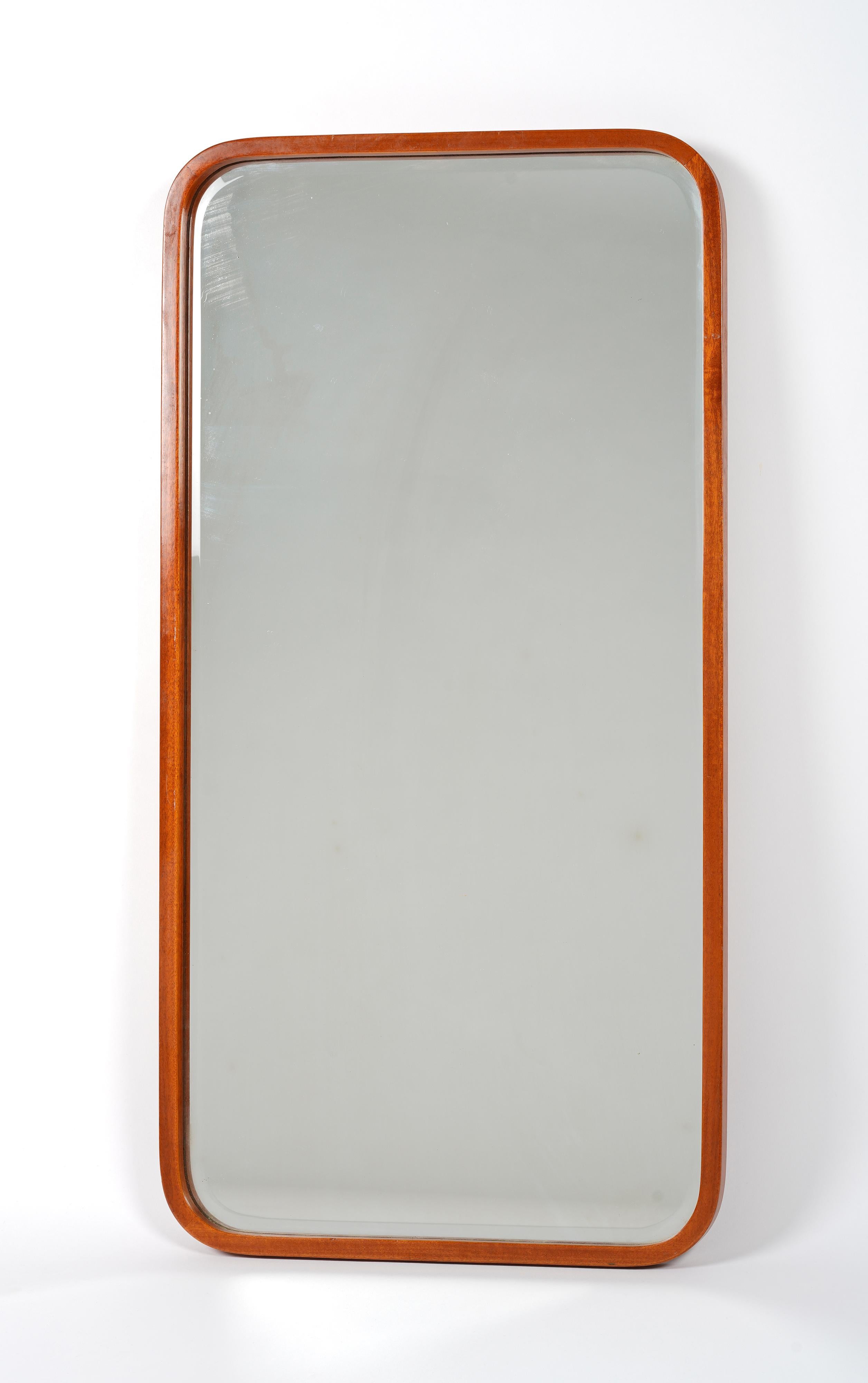 A swedish modern rectangular mirror. It holds a thin elegant frame in mahogany with rounded corners. Unknown swedish designer. Produced in the 1940s. 

Good original condition. 