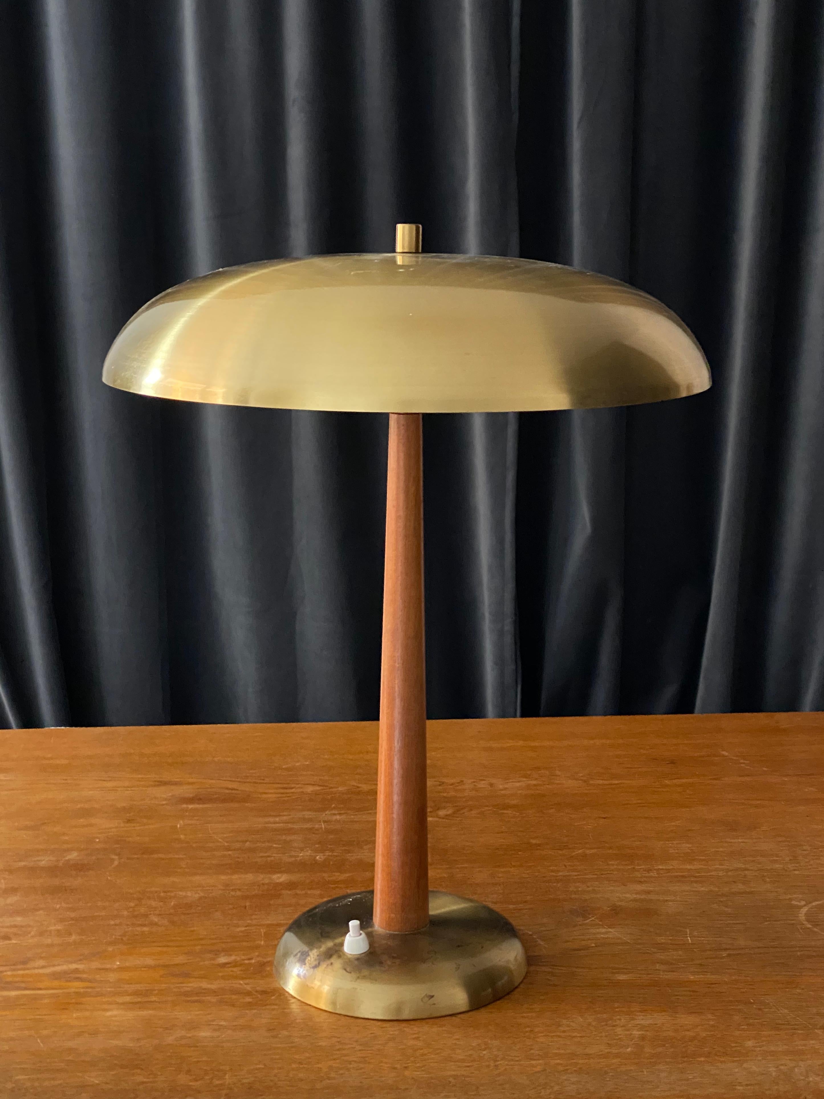 An early modernist table lamp. In brass and stained oak. Produced in Sweden, 1940s.

Other designers of the period include Paavo Tynell, Lisa Johansson-Pape, Carl-Axel Acking, and Gunnar Asplund.
