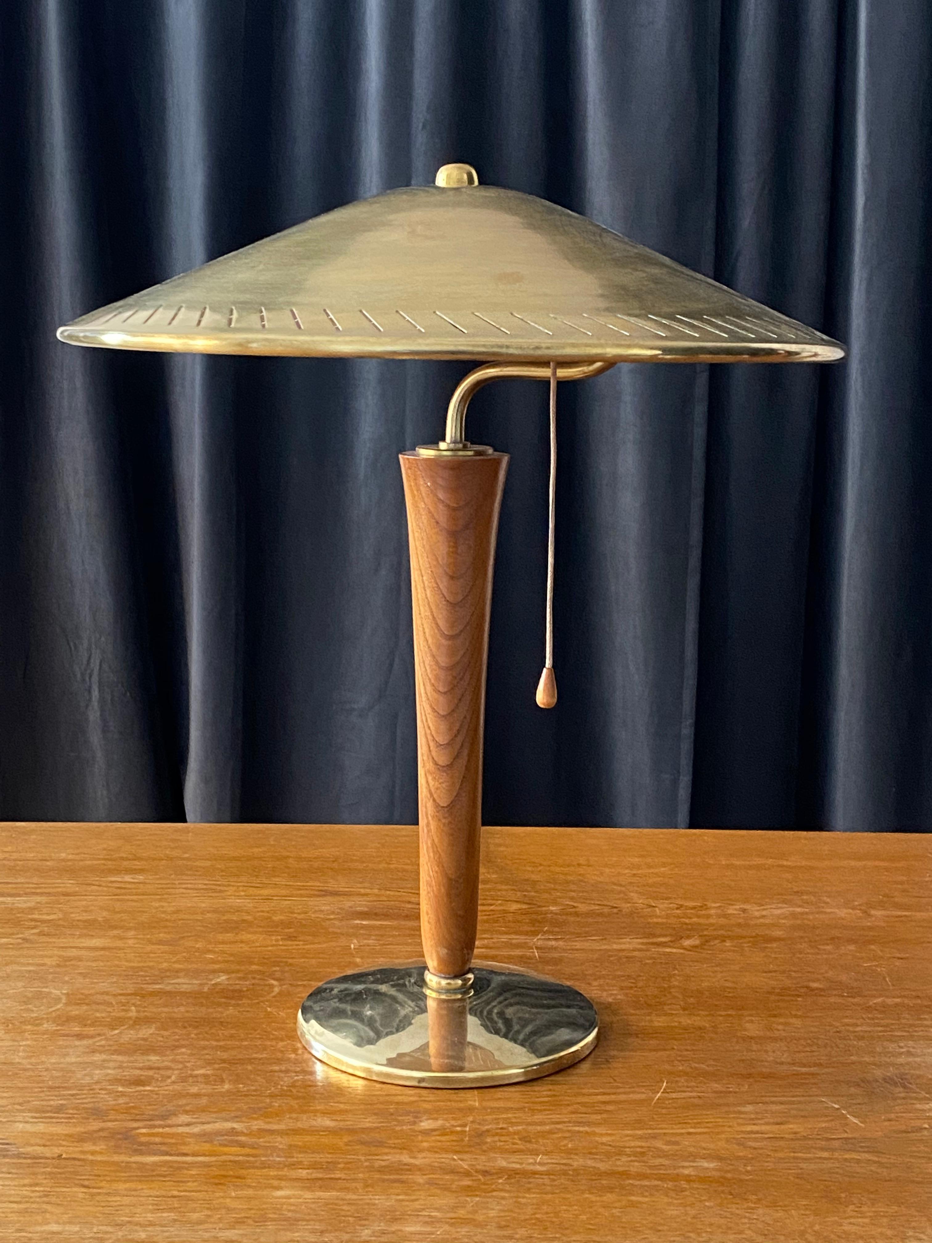 An early modernist table lamp. In brass and wood. Produced in Sweden, 1940s.

Other designers of the period include Paavo Tynell, Lisa Johansson-Pape, Carl-Axel Acking, and Gunnar Asplund.