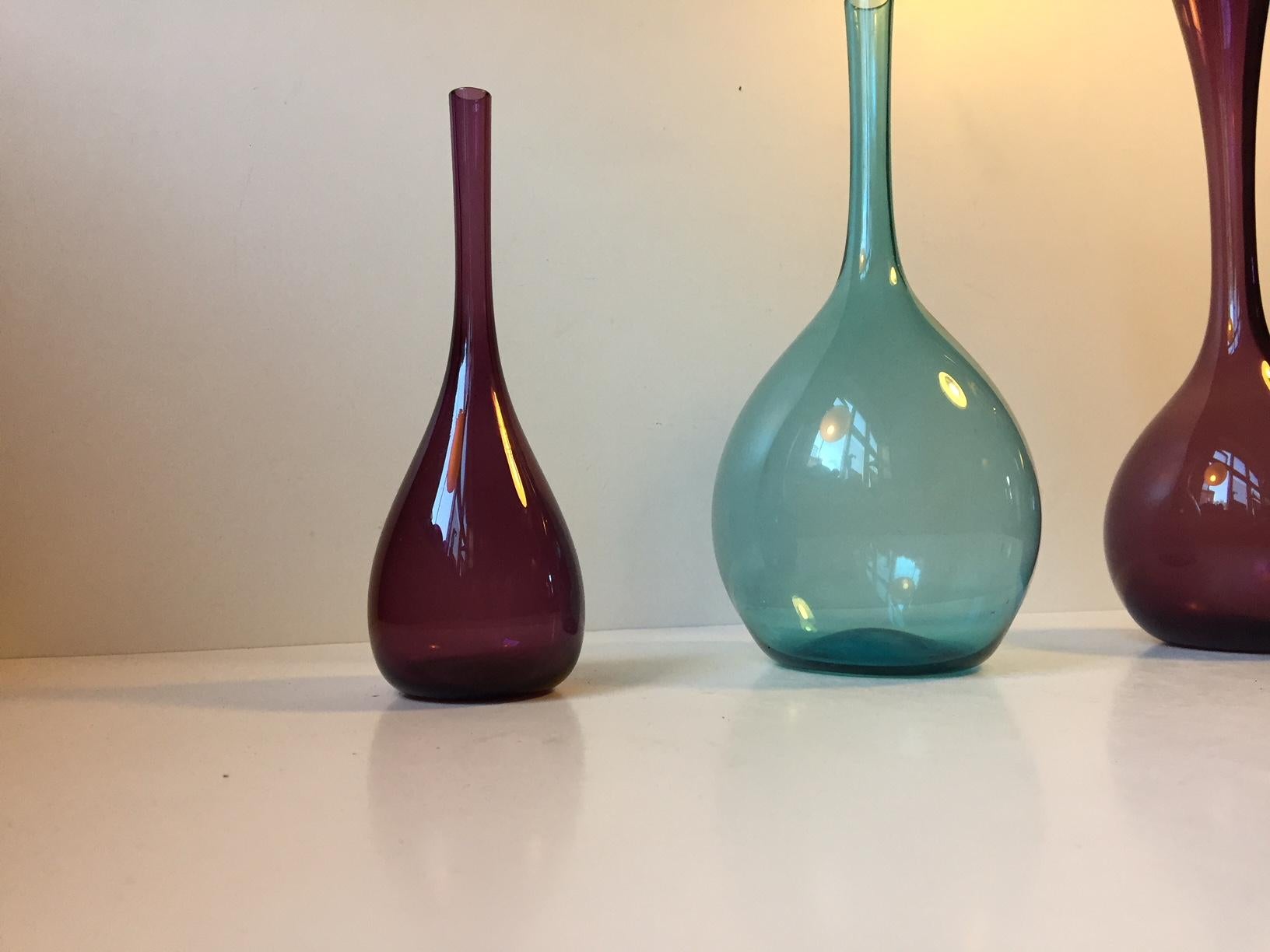 Mouth-blown delicate vases in light-blue and amethyst glass. Designed by Arthur Percy in 1952 and manufactured by Gullaskruf in Sweden. Measures: Height 28/25/19 cm - 11/10/7.5 inches.