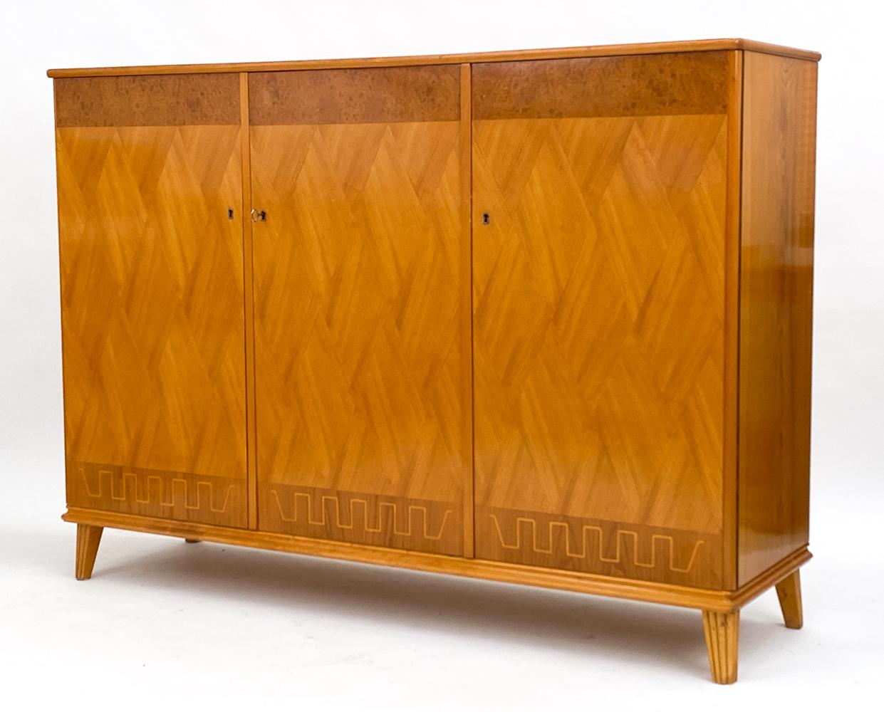 This attractive sideboard case piece is a stunning example of the Swedish Modern tradition. It has been attributed to the Swedish manufacturer Bodafors,  and was likely designed by the renowned Carl-Akel Acking.

Crafted from several different kinds