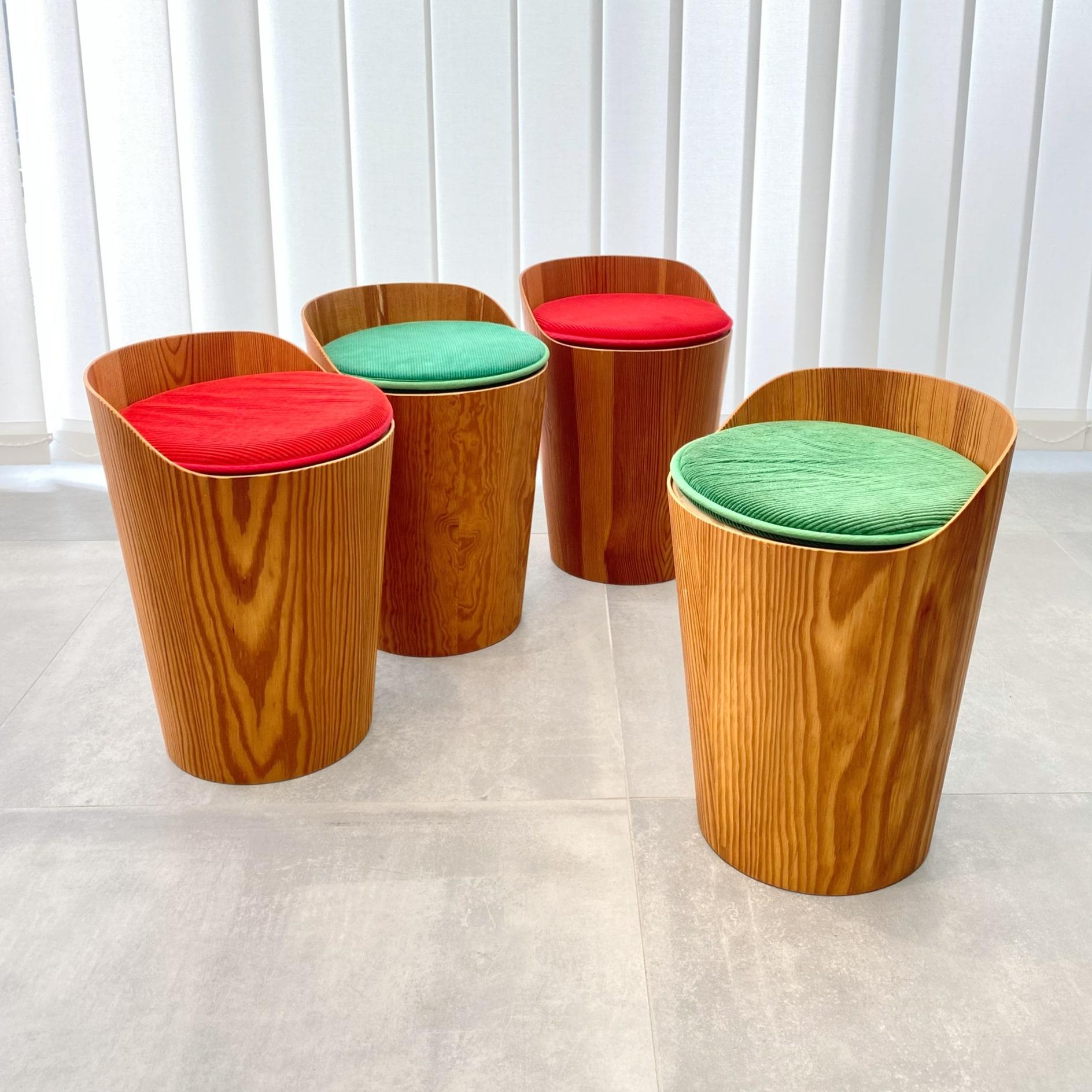 A set of four small Swedish modernist stools designed by Martin Åberg, produced in the 1960s by the manufacturer Servex. Crafted from molded pine veneer with a cylindrical seat at the top. Each stool has a loose cushion with original corduroy