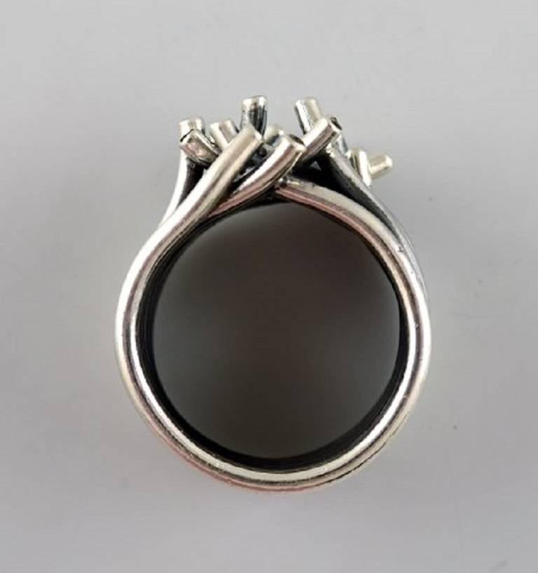 Swedish modernist sterling silver ring with 14 brilliants.
Size: 20 mm. Our silversmith can adjust to any size for an additional $50.
Marked 925 s. 1960 / 70s.
In very good condition.
LARGE SELECTION OF modernist SILVER FROM 1960/70 IN STOCK.