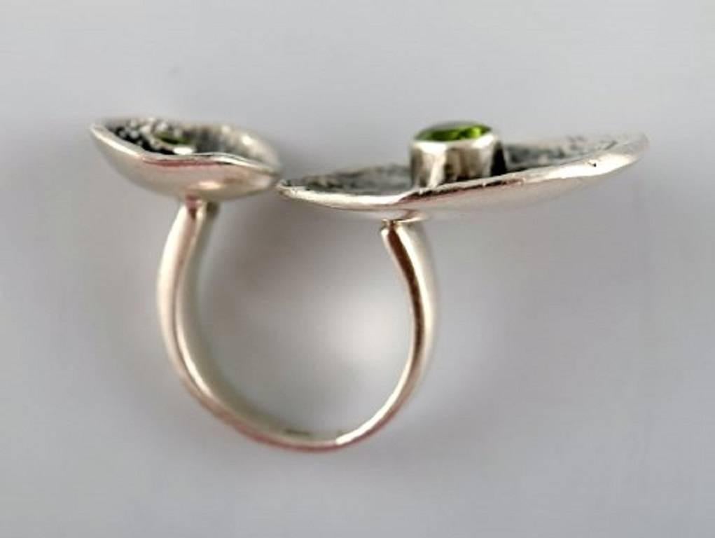 Swedish modernist sterling silver ring with two green stones in organic form.
Size: 20 mm. US Size 10-10½. Our silversmith can adjust to any size for an additional $50.
Marked: 925s. 1960 s.
In very good condition.
LARGE SELECTION OF modernist
