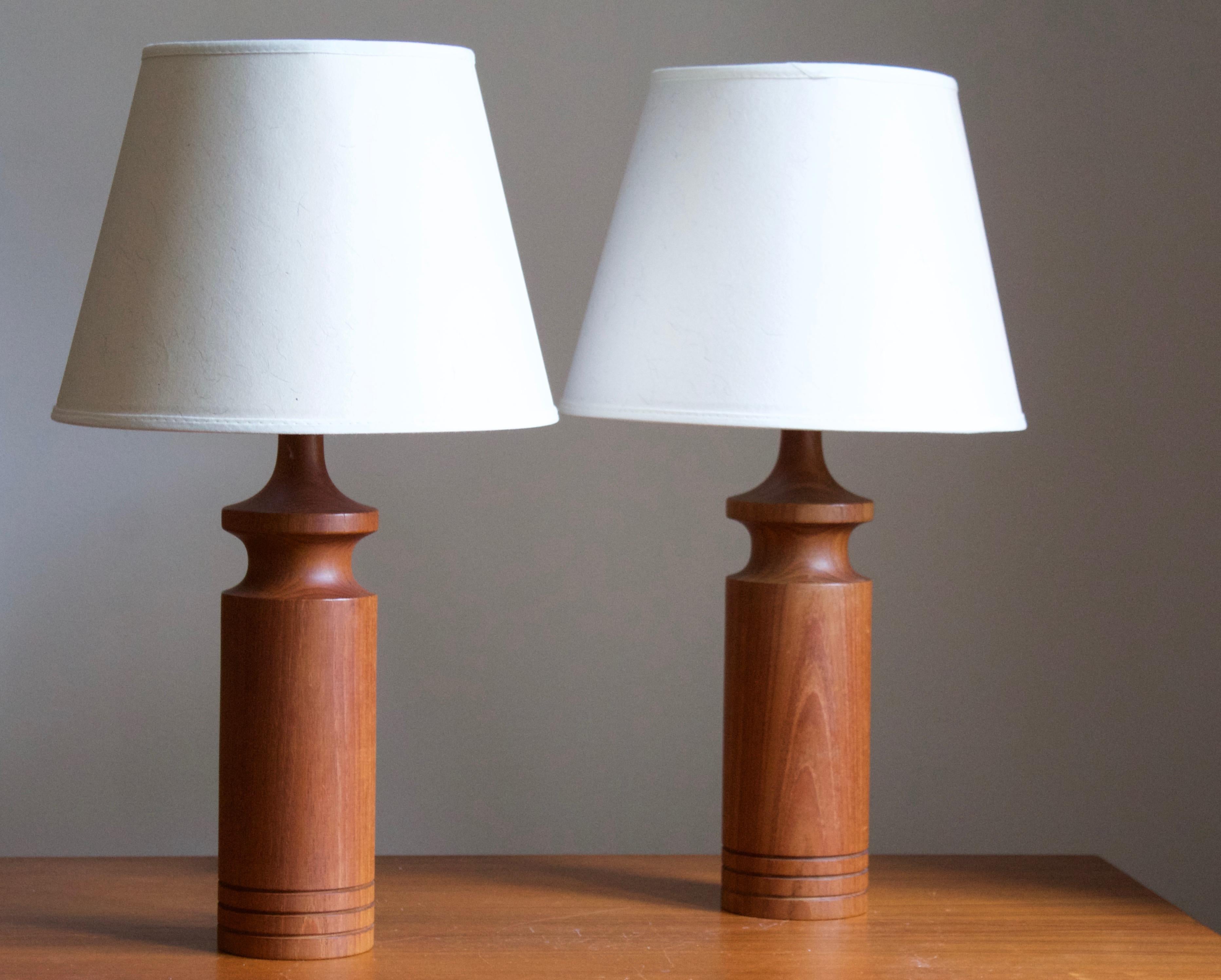 A pair of finely turned solid teak table lamps. Produced in Sweden, 1960s. 

Stated dimensions exclude lampshades, height includes socket. Sold without lampshades.

Other designers of the period include Hans Agne Jacobsen, Josef Frank, Palshus,