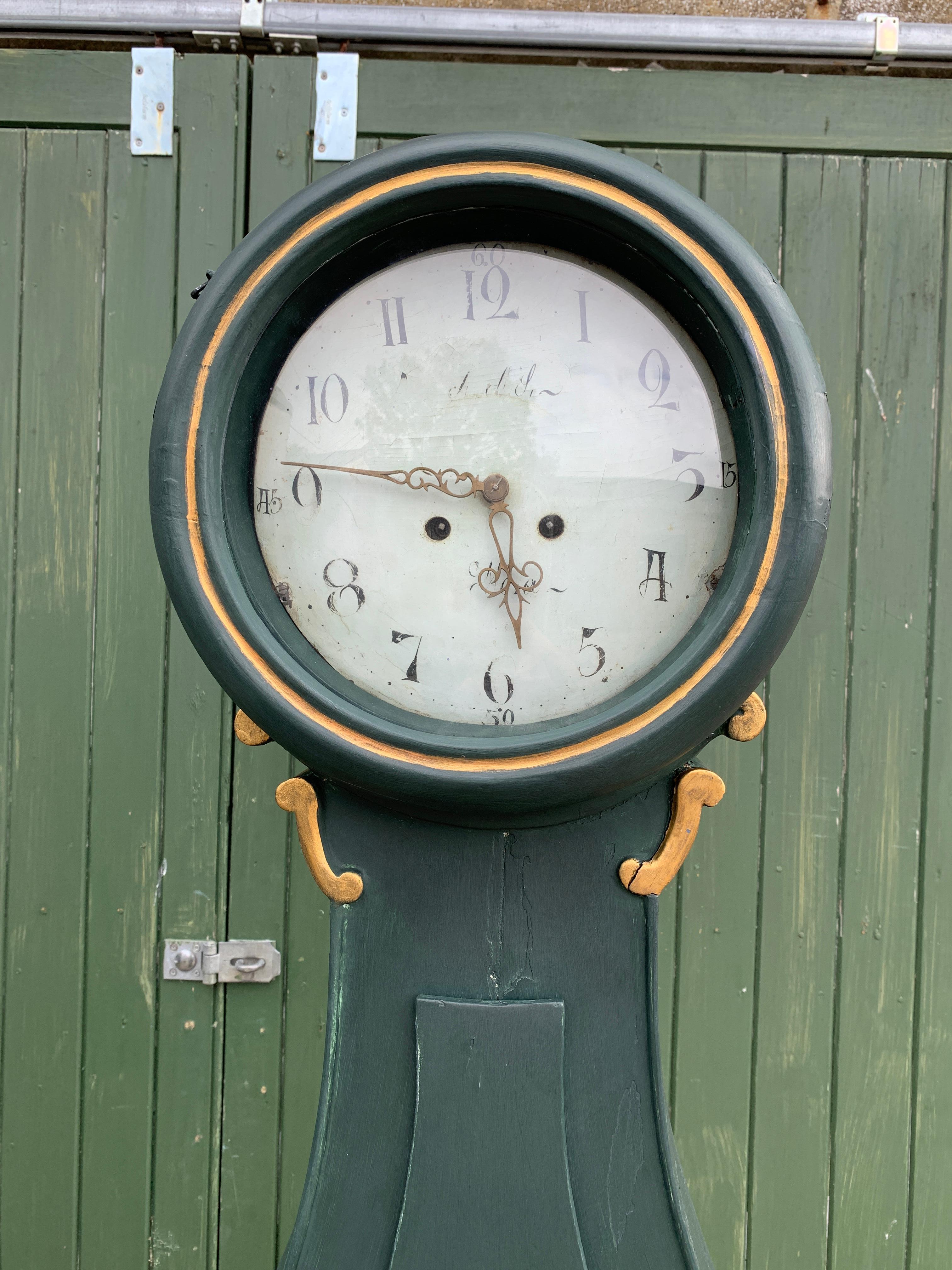 Decorative early 1800s antique Swedish mora clock with scroll and swag detail in a fryksdal influenced style and later paint. 

Measures: 210cm.

This original 1800s mora clock has a beautiful face with a clean patina and some enamel