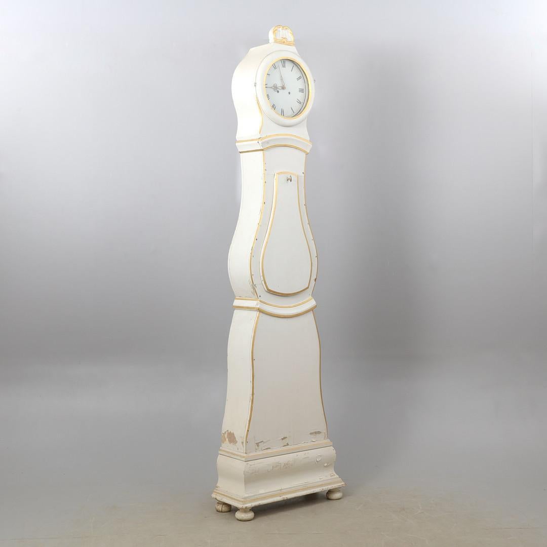 Decorative early 1800s antique Swedish mora clock with carved detail in a white and gold paint finish - it is a rare and exceptionally tall clock at 235cm and very statuesque. The paint is fairly distressed in places as noted in the photos

This