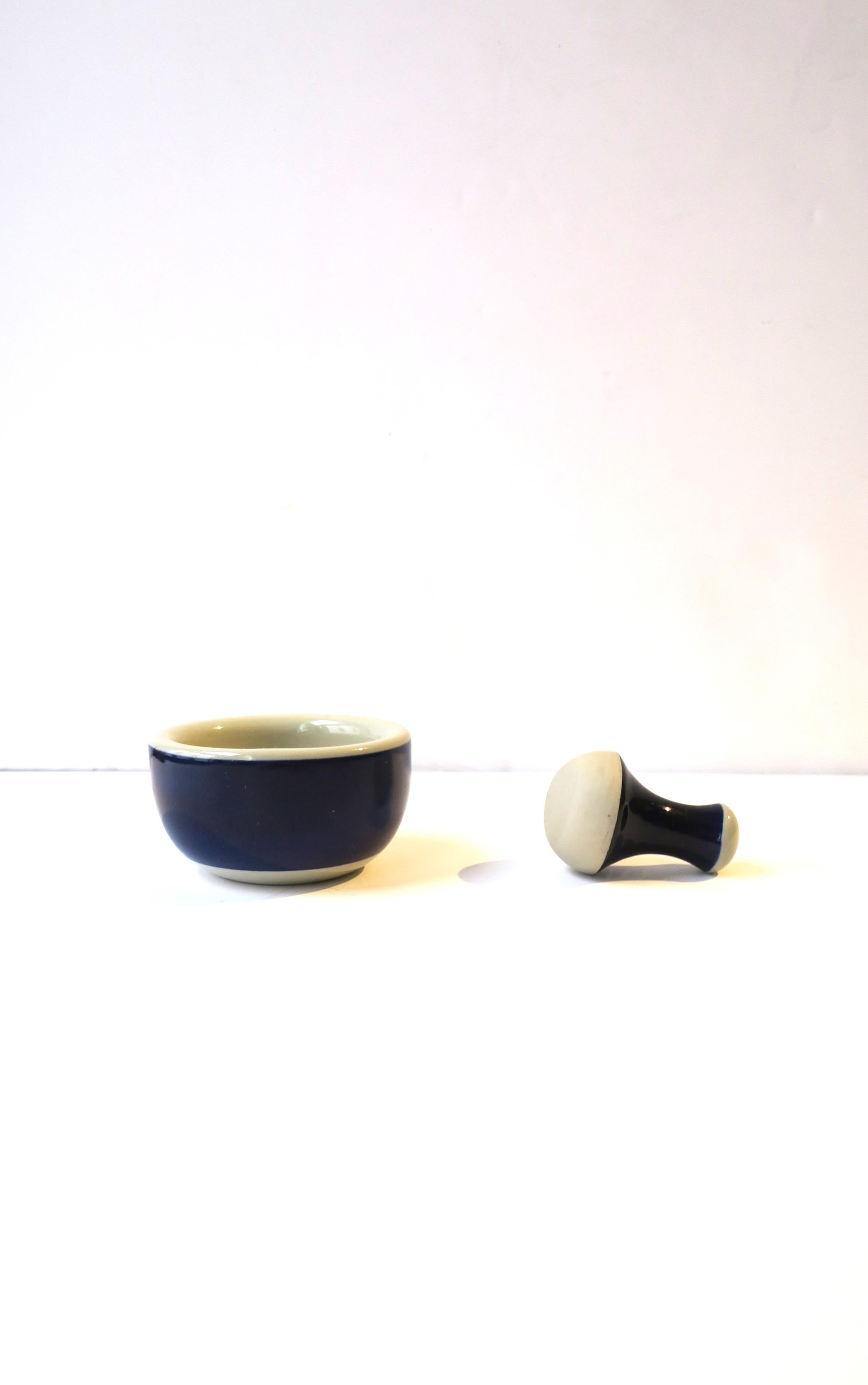 A Swedish blue and stone-white porcelain mortar and pestle set, in the Scandinavian Modern style, by Rörstrand, circa late-20th century, Sweden. Piece is stone-white and sapphire blue hues. Piece is hand-painted and made in Sweden as marked. Pestle