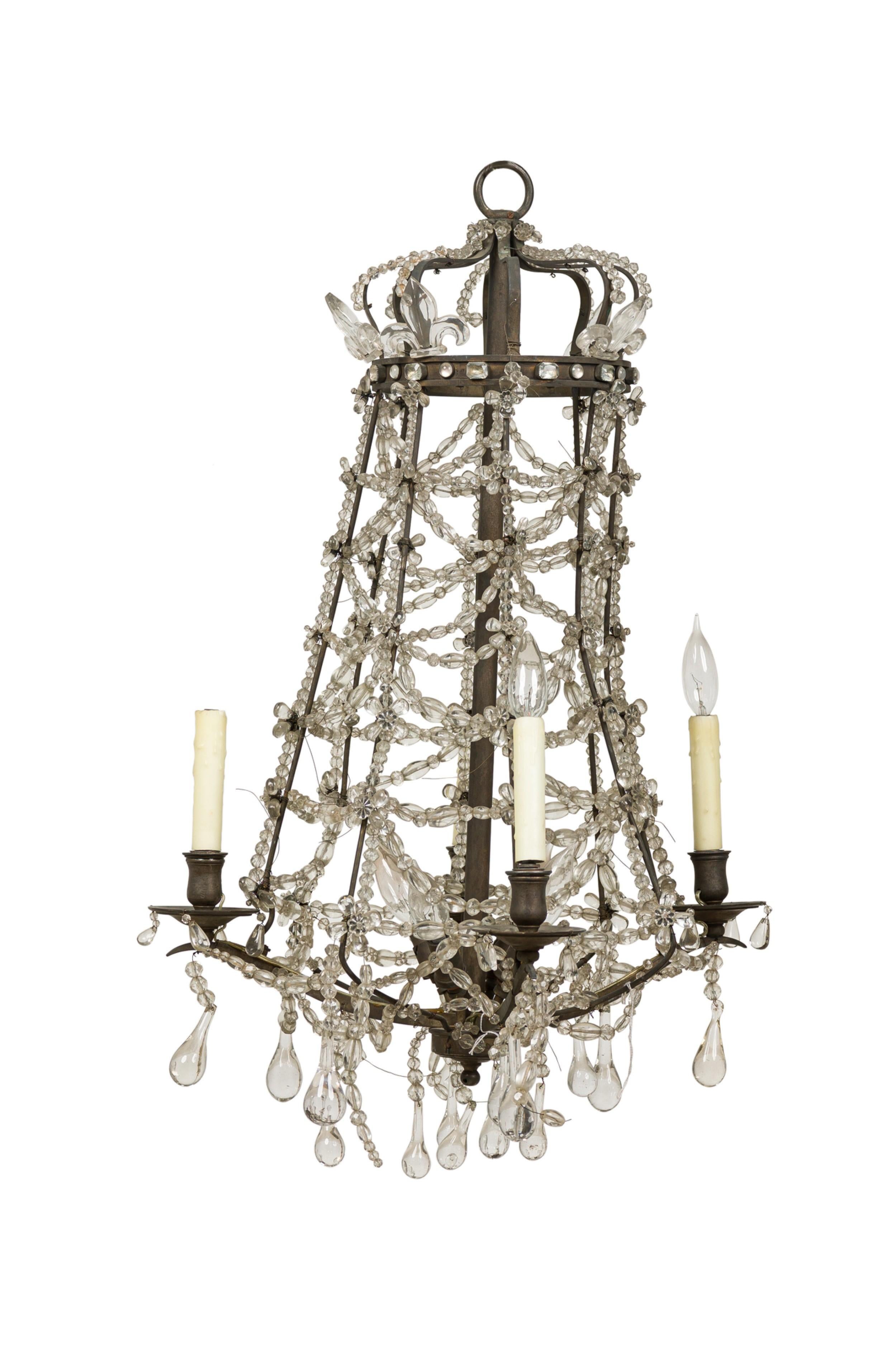 Swedish Neo-Classic (Early 19th Century) crystal chandelier with a tapered brass frame featuring a crown top, crystal Fleur-de-lis, beads and pendants, 4 arms with candelabra and 4 additional interior lights.
 

 Wear to finish.
