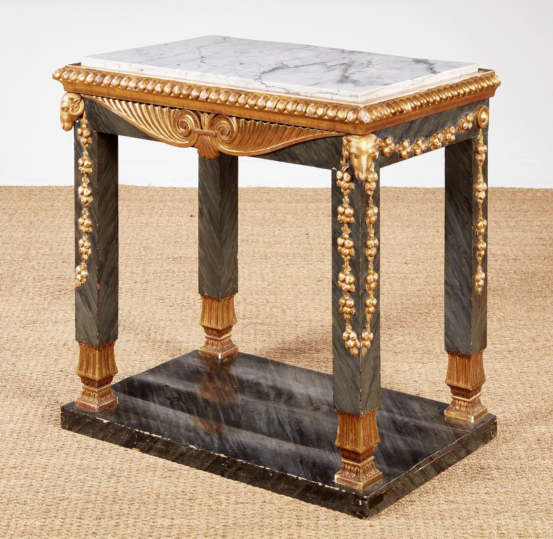 An impressive early 19th century Swedish neoclassical Gustavian console table with white marble top on faux marbleized apron and legs above marbleized plinth base, having giltwood detailing including ram's heads, laurel garlands, carved feet,