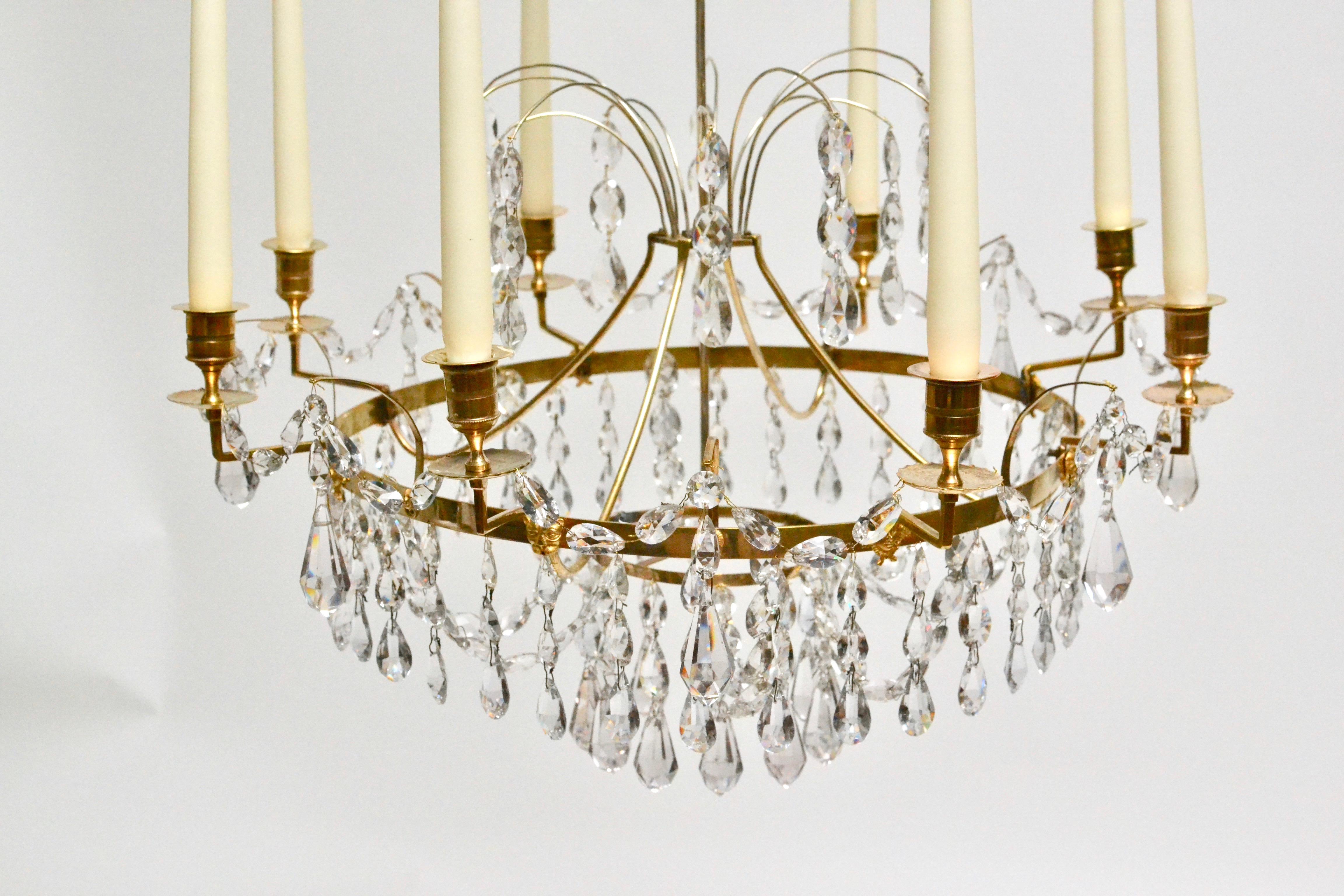 Swedish neoclassical ormolu and cut-glass six-light chandelier made in Stockholm, circa 1790. The corona issuing droplet-hung sprays and hanging from it are cut-glass chains, the main circlet with ormolu lion heads mounted is attached through four