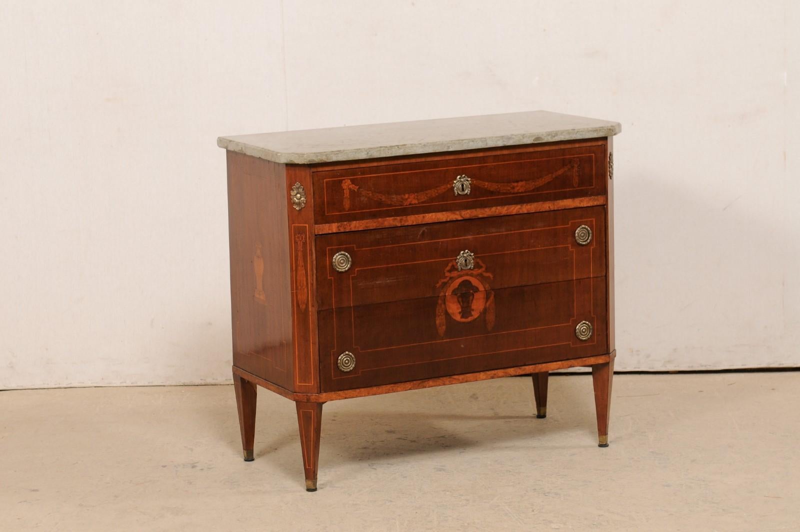 A Swedish period Karl Johan inlaid wood chest with original stone top from the early 19th century. This antique chest from Sweden features a stone top (Kalmar region) which rests atop a case which houses three dove-tailed graduated drawers, flanked