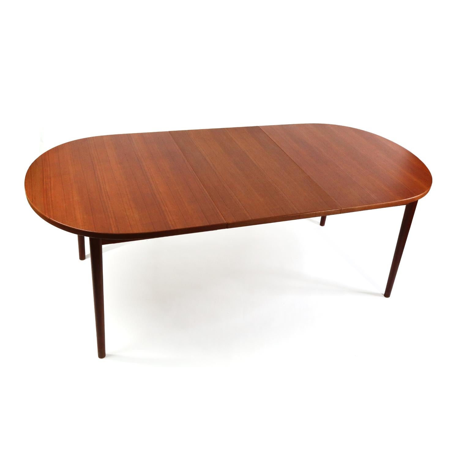 Stunning expanding Mid-Century Modern teak dining table by Nils Jonsson for Troeds. The Swedish made dining table comes with two large leaves. The table is stands at 61? long when compact. Even at compact size, you can seat six. Each leaf is 21.5?