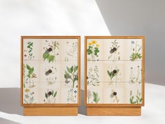 Swedish Nordens Flora Illustrations on Pair of Blonde Mahogany Nightstands