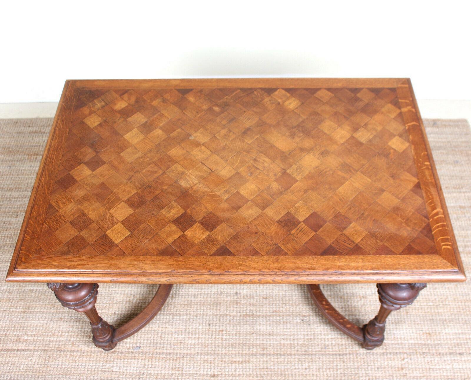 An impressive 19th century Swedish carved oak parquetry table.
Constructed from thick cuts of solid oak boasting a well figured grain.
The top boasting parquetry inalys, carved chamfered edges and raised on finely worked turned and fluted legs
