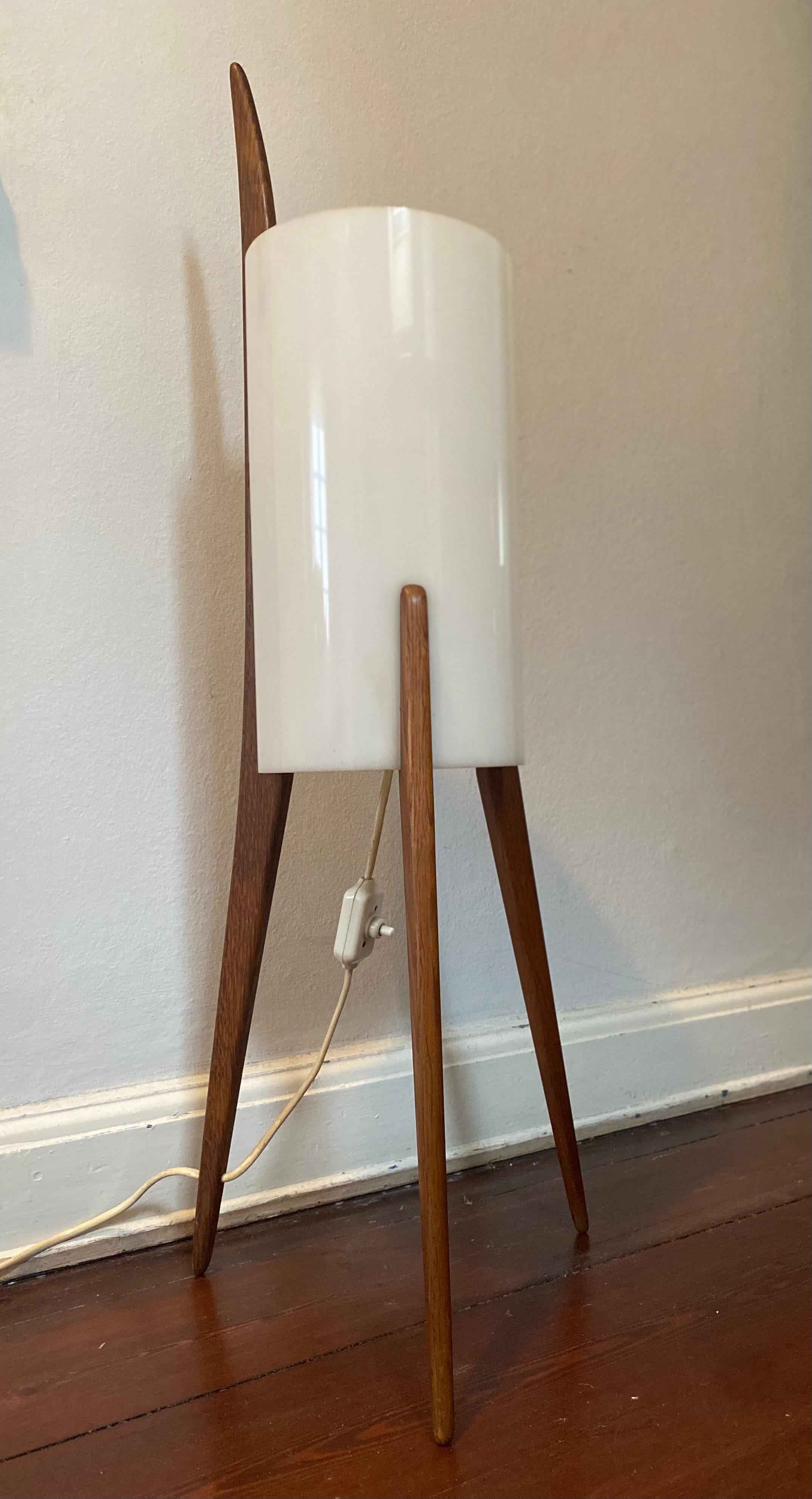 This rare floor lamp (model no. 308) was designed by Uno & Östen Kristiansson for Luxus in the 1960's in Sweden. The three-legged stand is made from oak and the cylander shaped shade is of Plexiglass, which gives it a beautiful soft light. It is not