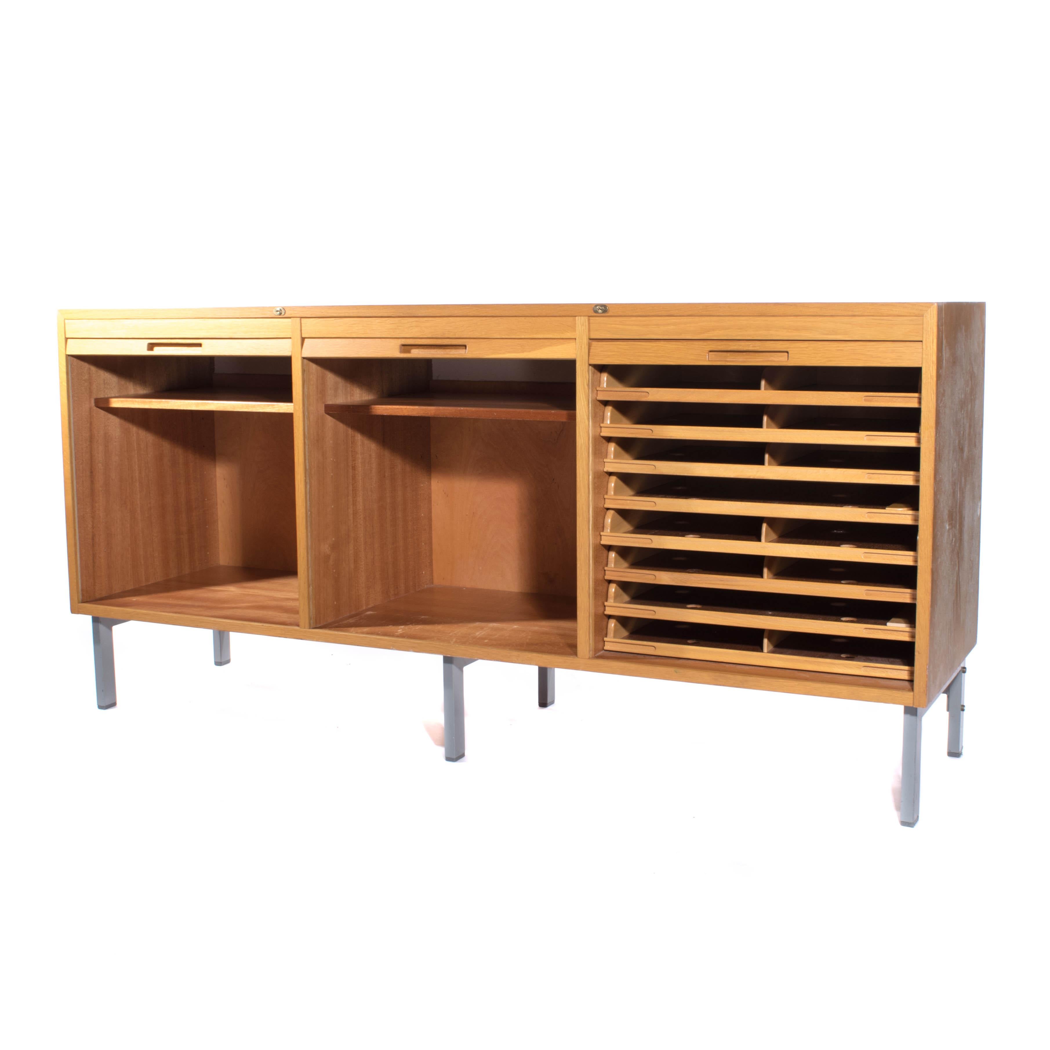 1960s sideboard or credenza made of light oak with rolling doors and metal legs.
