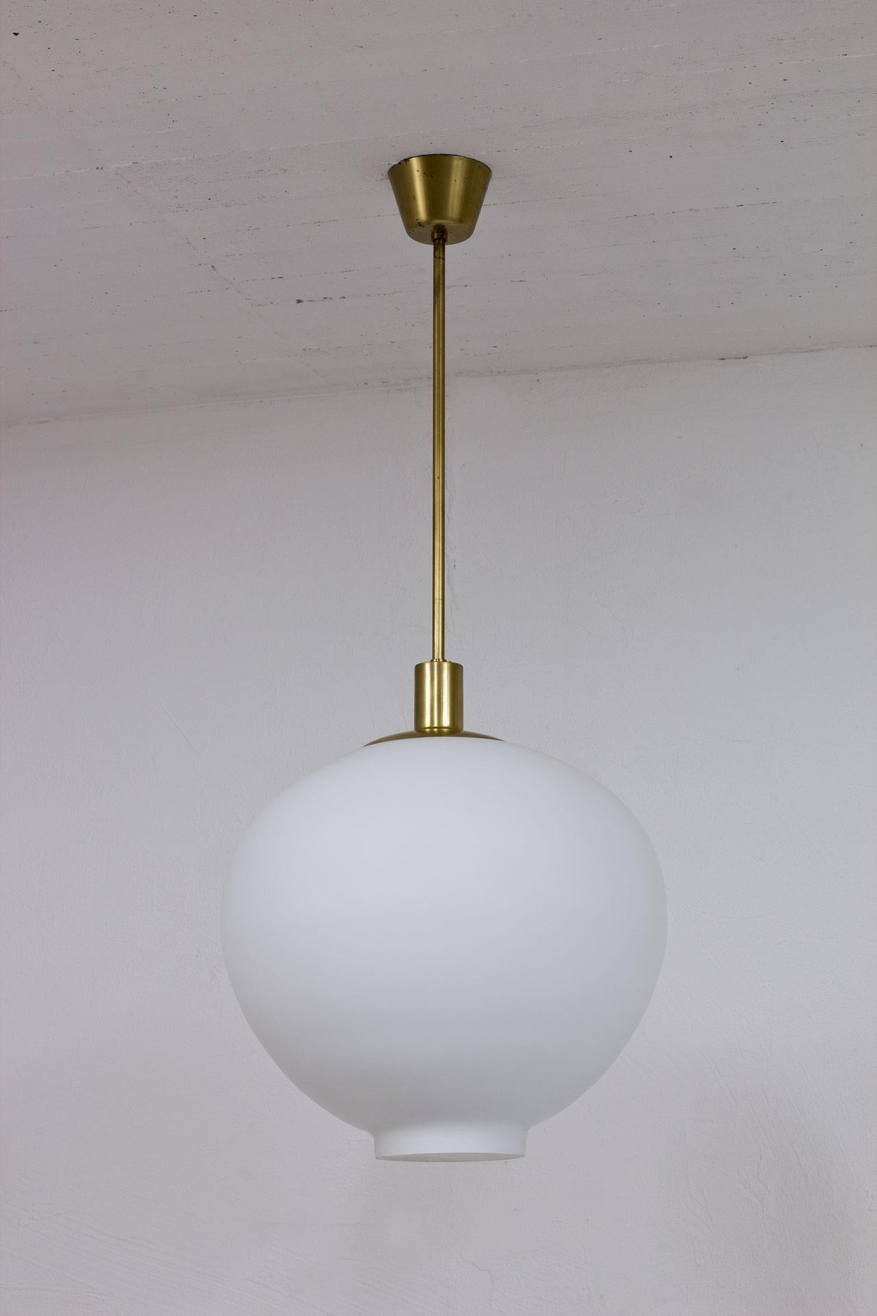 Large ceiling lamp design attributed to Uno Westerberg for Böhlmarks. 
Manufactured in Sweden during the late 1940s (design from 1946).
Opaline glass diffuser with matte brass fittings.
New wiring.