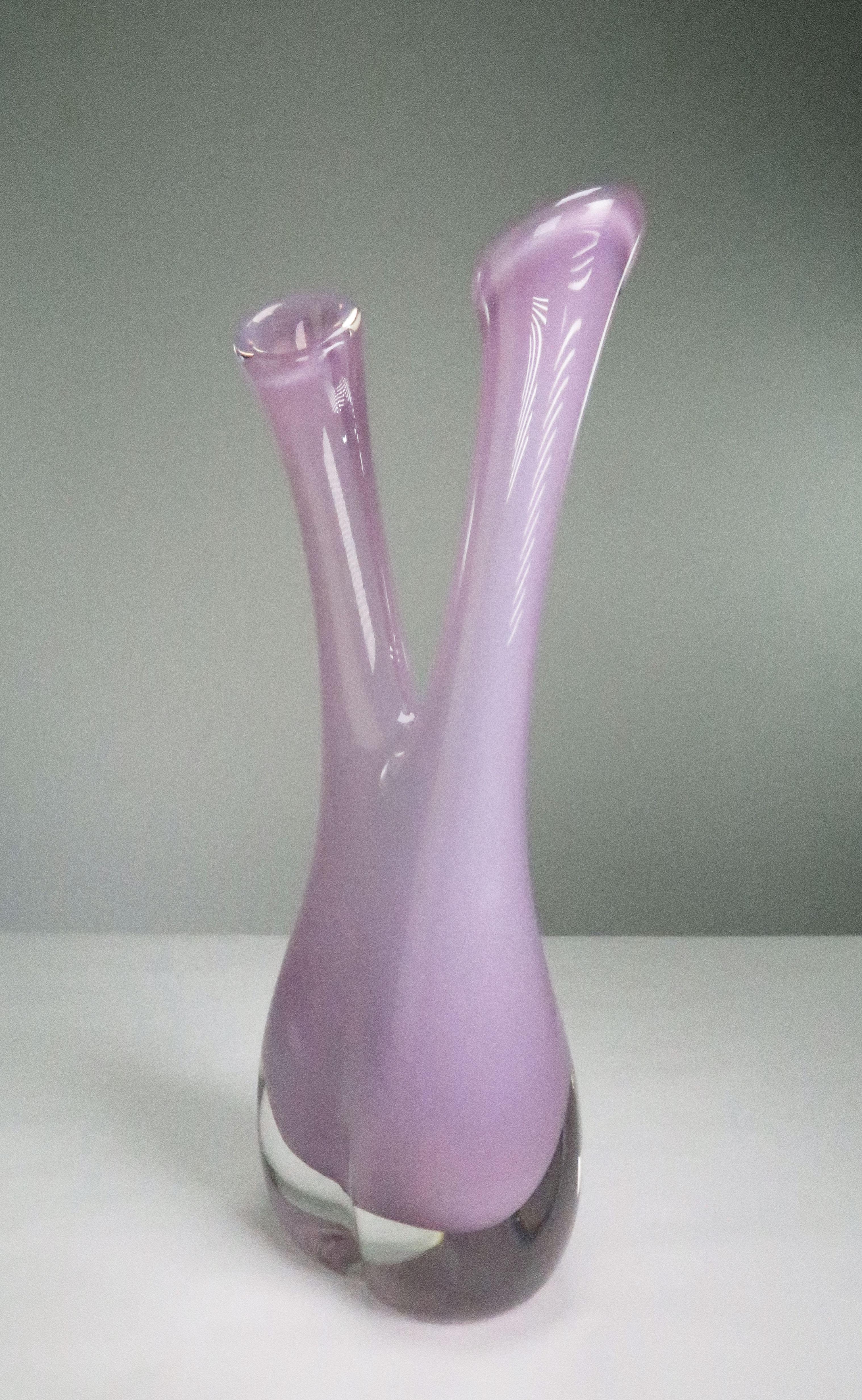 Delicate, stunning Swedish Mid-Century Modern mouth blown art glass vase with two necks and a thick solid rounded base. Light rose, orchid pink colored glass encased in clear glass. Created and manufactured at Swedish Sea Glasbruk in Kosta in the