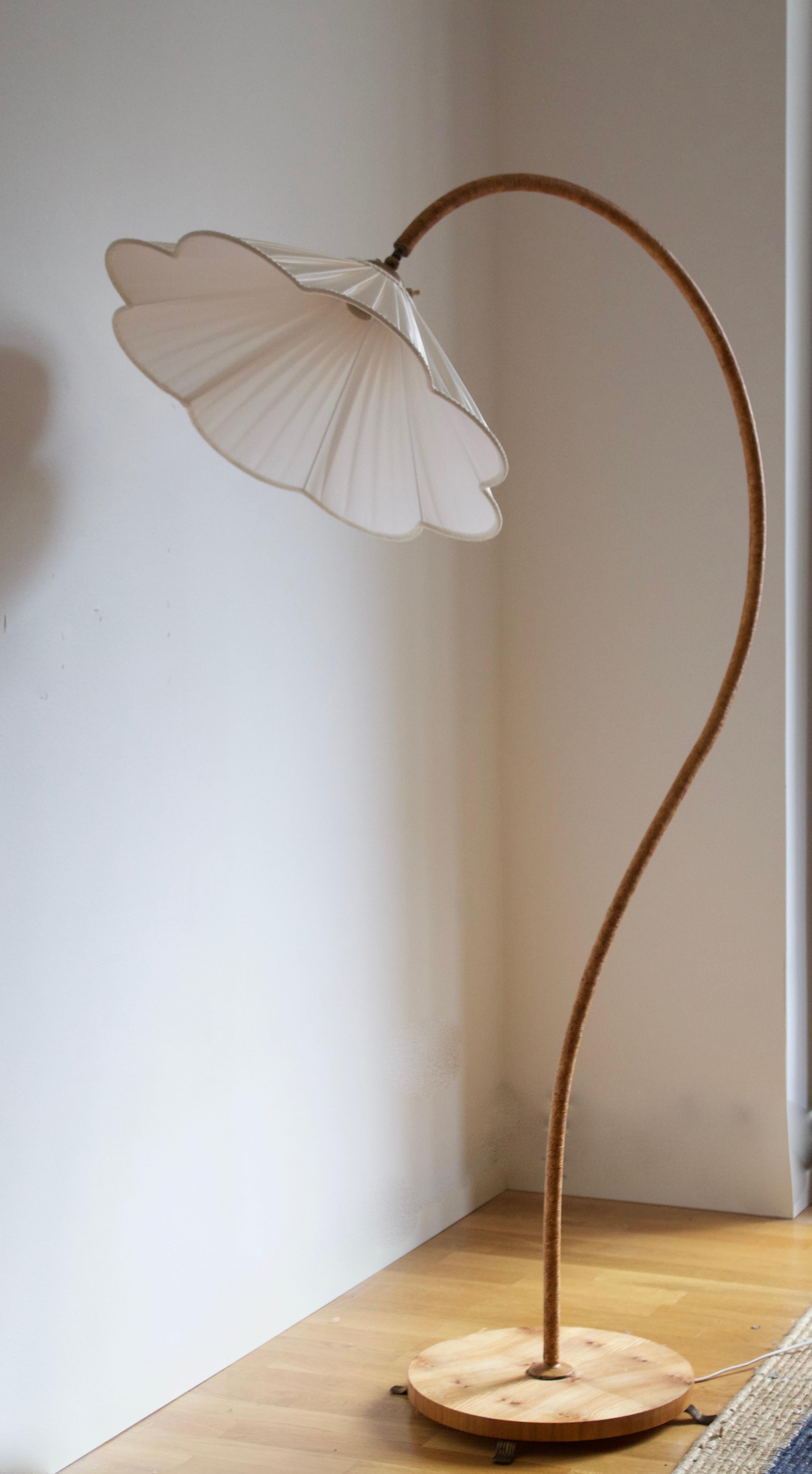An organic floor lamp. Designed by an unknown Swedish modernist designer, c. 1940s. Produced in brass, pine, cord and brass. Brand new high-end lampshade.

Other designers working in the organic style include Jean Royère, Gio Ponti, Vladimir
