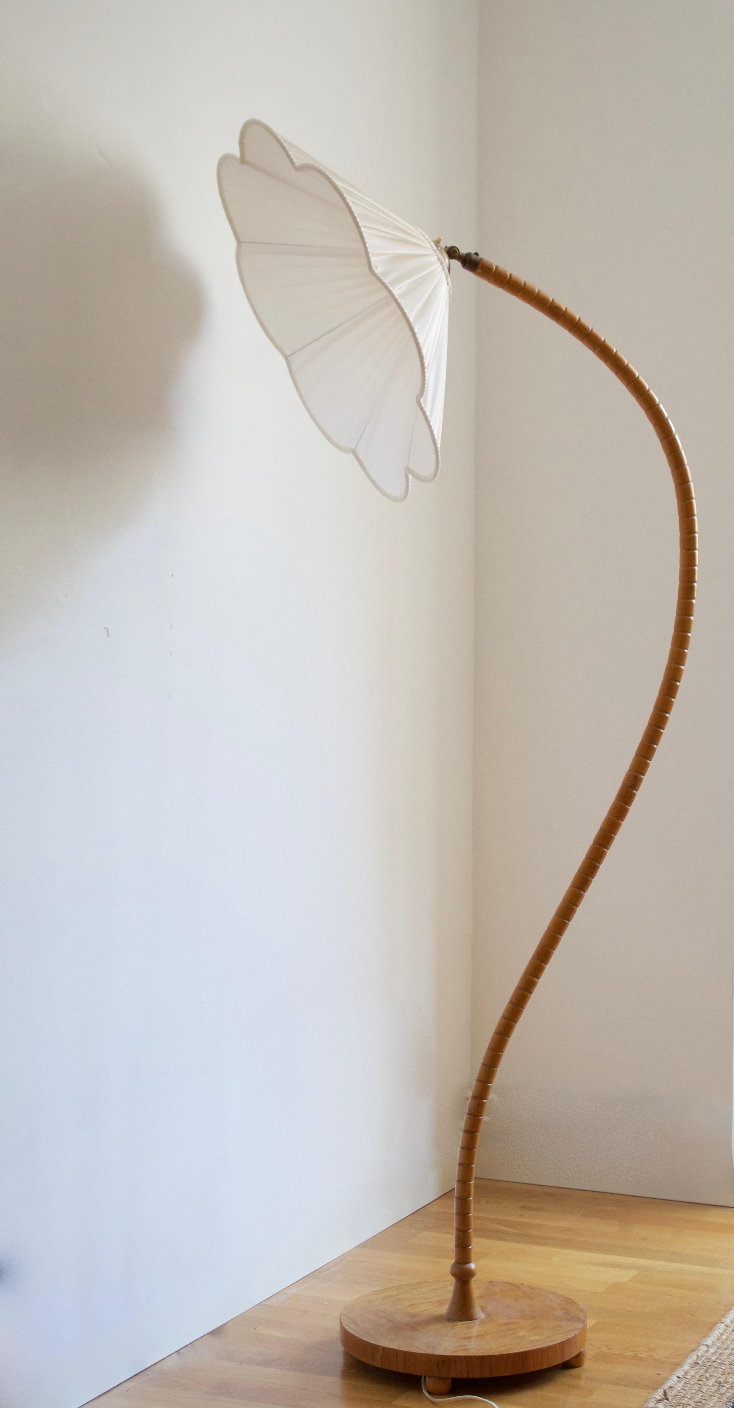An organic floor lamp. Designed by an unknown Swedish modernist designer, 1930s. Produced in birch, fabric, and brass. Brand new high-end lampshade.

Other designers working in the organic style include Jean Royère, Gio Ponti, Vladimir Kagan, Ico