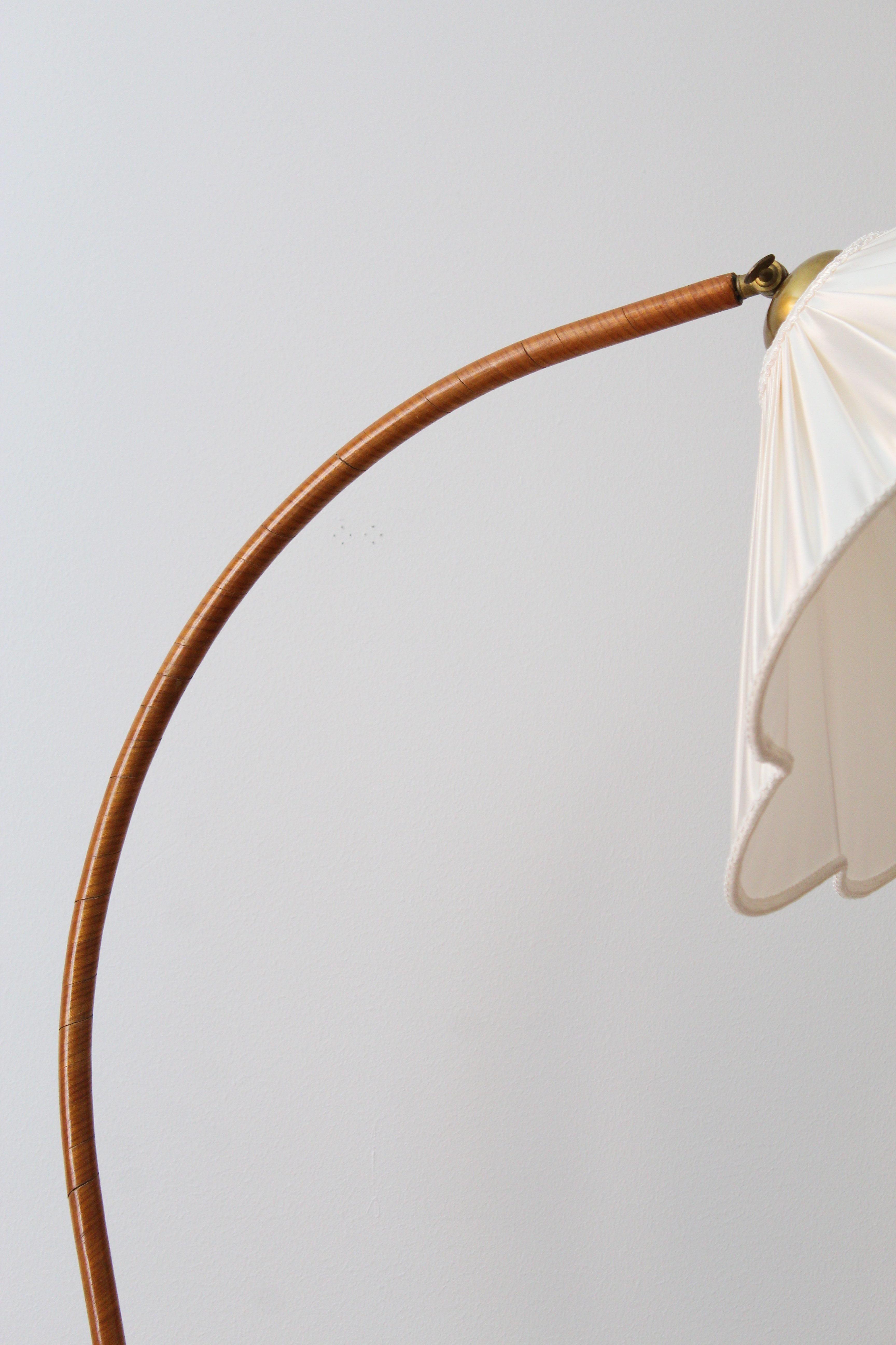 An organic floor lamp. Designed by an unknown Swedish modernist designer, 1930s. Produced in wood, fabric, and brass. 

Other designers working in the organic style include Jean Royère, Gio Ponti, Vladimir Kagan, Ico Parisi, and George Nakashima.