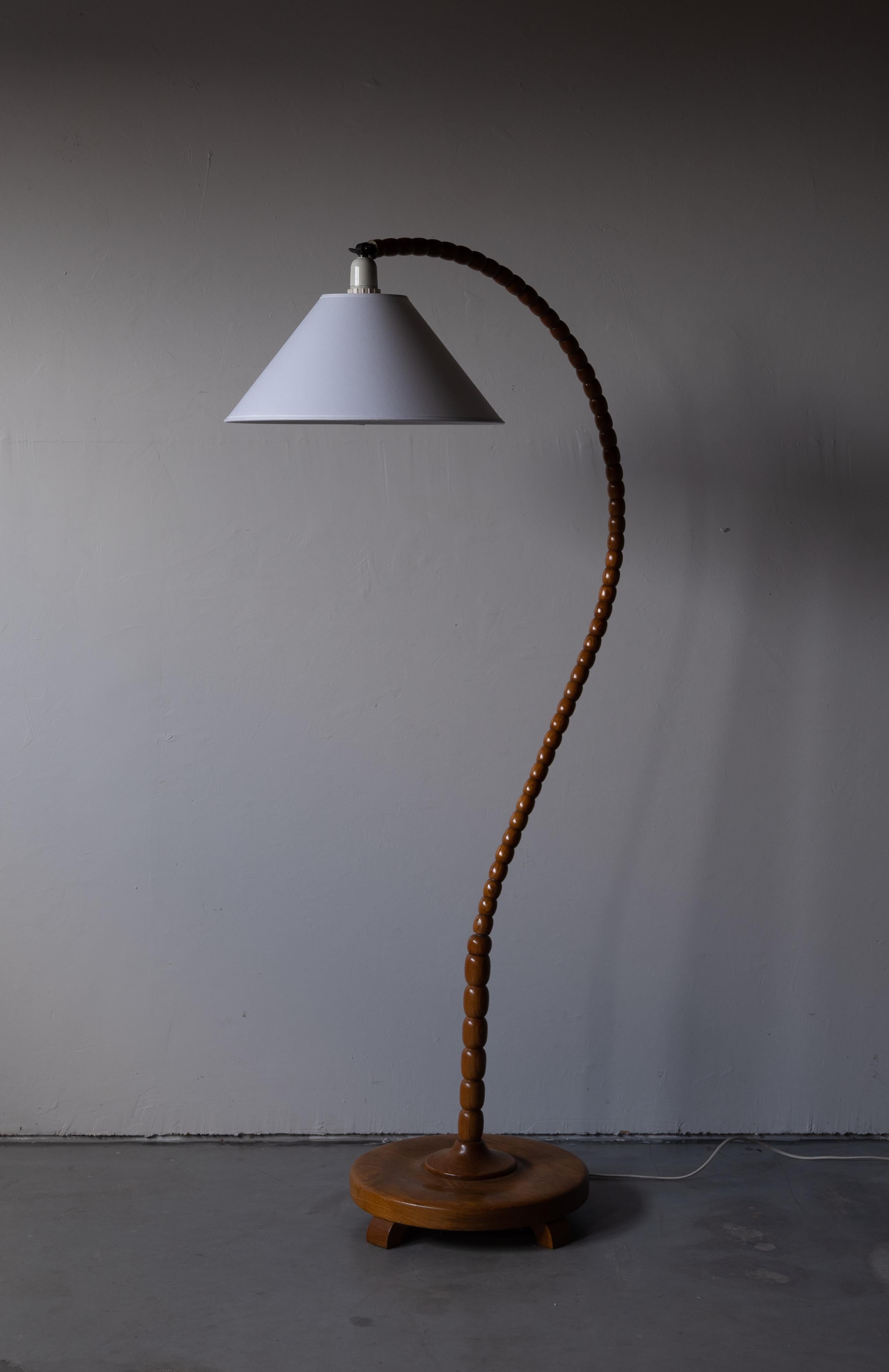 An organic floor lamp. Designed by an unknown Swedish modernist designer, 1930s. Produced in wood and brass. Brand new lampshade.

Other designers working in the organic style include Jean Royère, Gio Ponti, Vladimir Kagan, Ico Parisi, and George