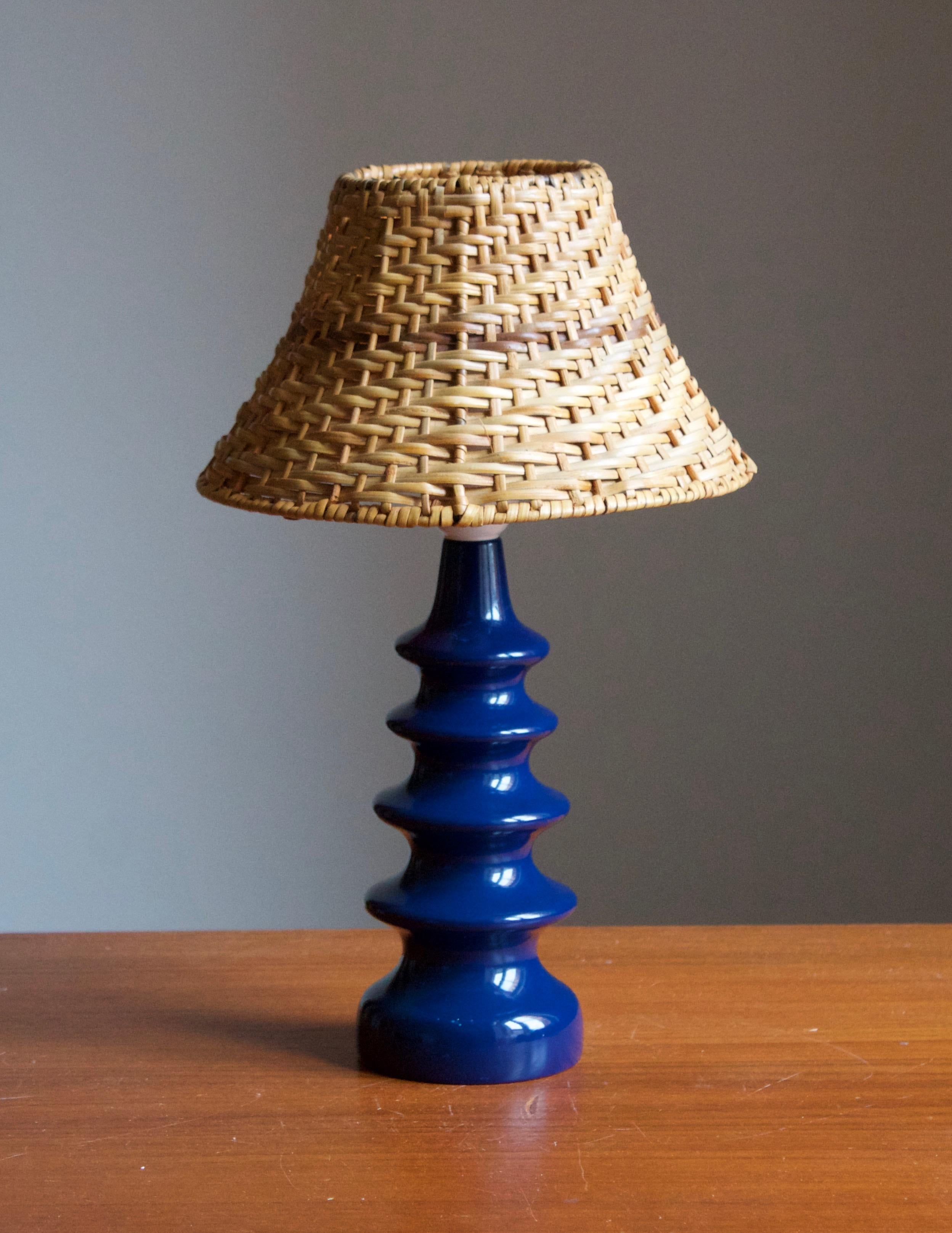 A pair of small pine table lamps, designed and produced in Sweden, c. 1970s. 

Stated dimensions exclude lampshade. Height includes socket. Assorted vintage rattan lampshade of illustrated model can be included upon request.