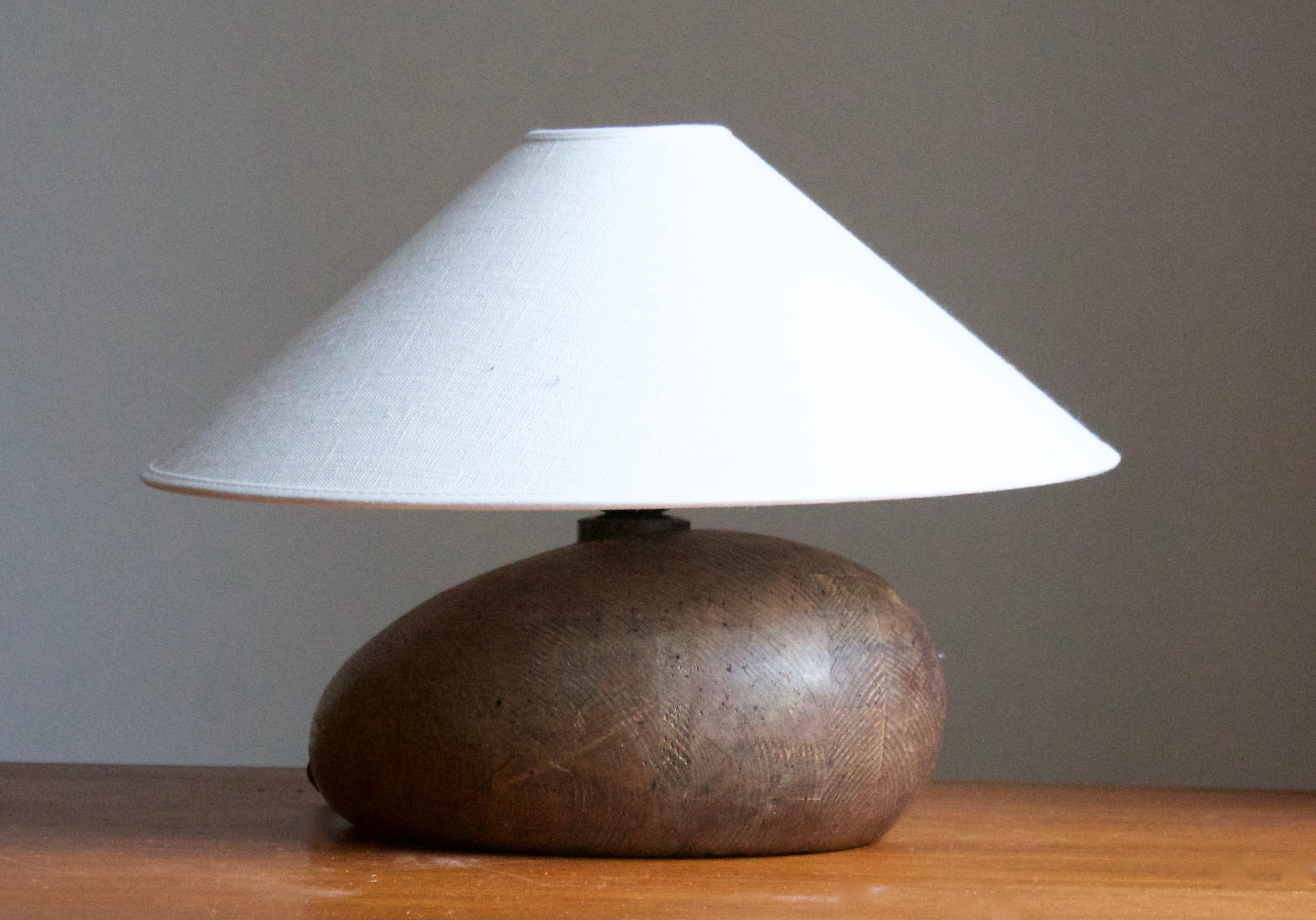 An organic shaped table lamp. Lamp mounted atop of organic wooden architectural element, Sweden, c. 1940s.

Stated dimensions exclude lampshade. Height includes socket. Shade is not included in purchase.